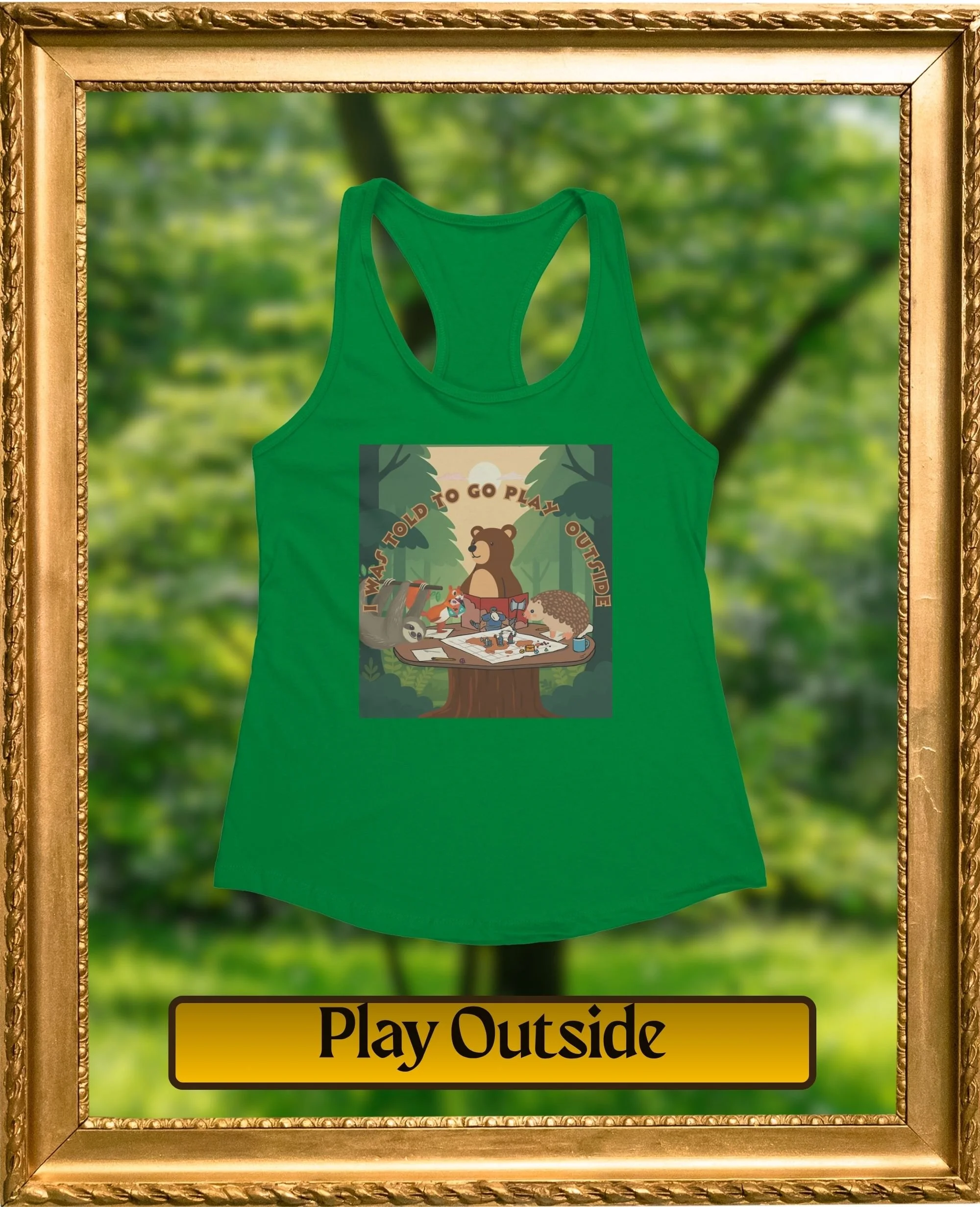 A green tank top hanging in a gold frame with a background of green trees and a yellow sign that says "Play Outside".