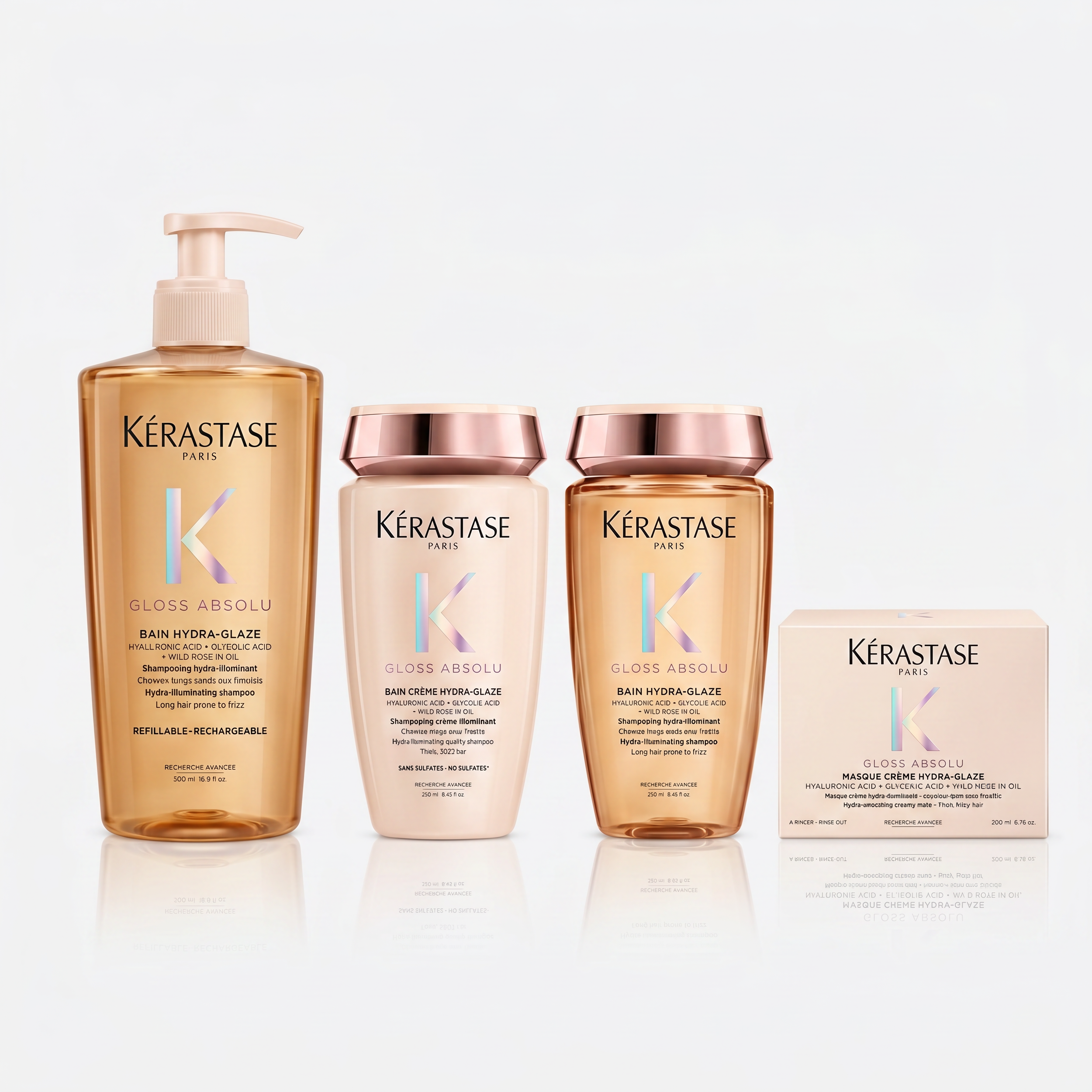 Three bottles of Kérastase Paris hair care products with reflection on a white background.