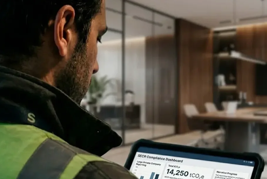 Engineer reviewing building energy compliance data on a tablet