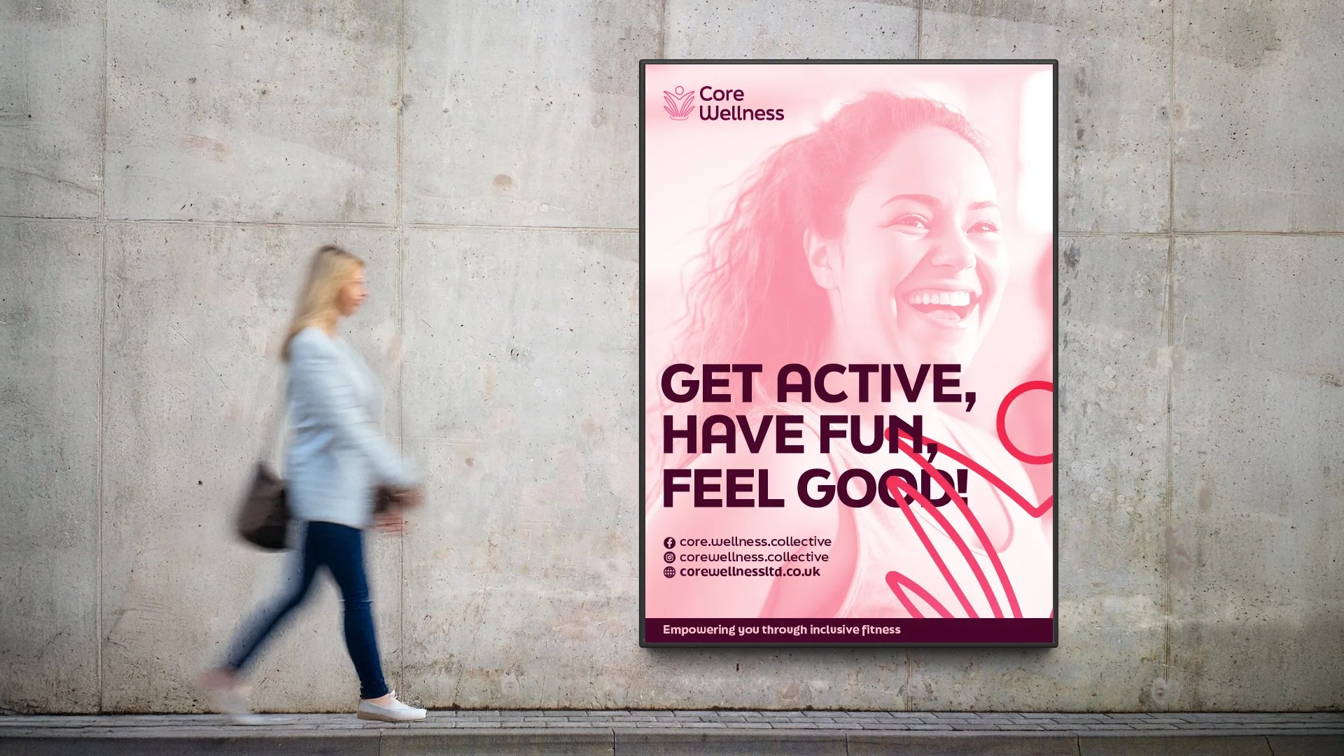 A woman walking past a pink and white advertisement poster on a concrete wall promoting Core Wellness. The poster features a smiling woman with the text 'GET ACTIVE, HAVE FUN, FEEL GOOD!' and includes social media icons and the website.