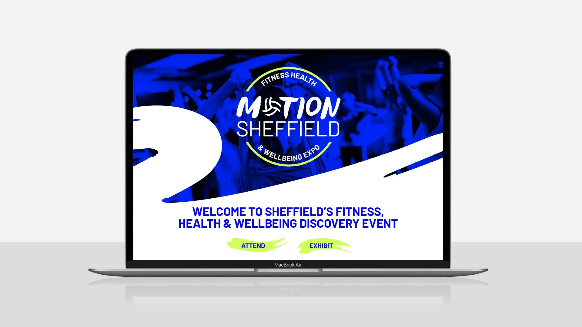 Laptop screen displays purple and white promotional poster for Sheffield's fitness, health, and wellbeing event, with text and graphic design elements.