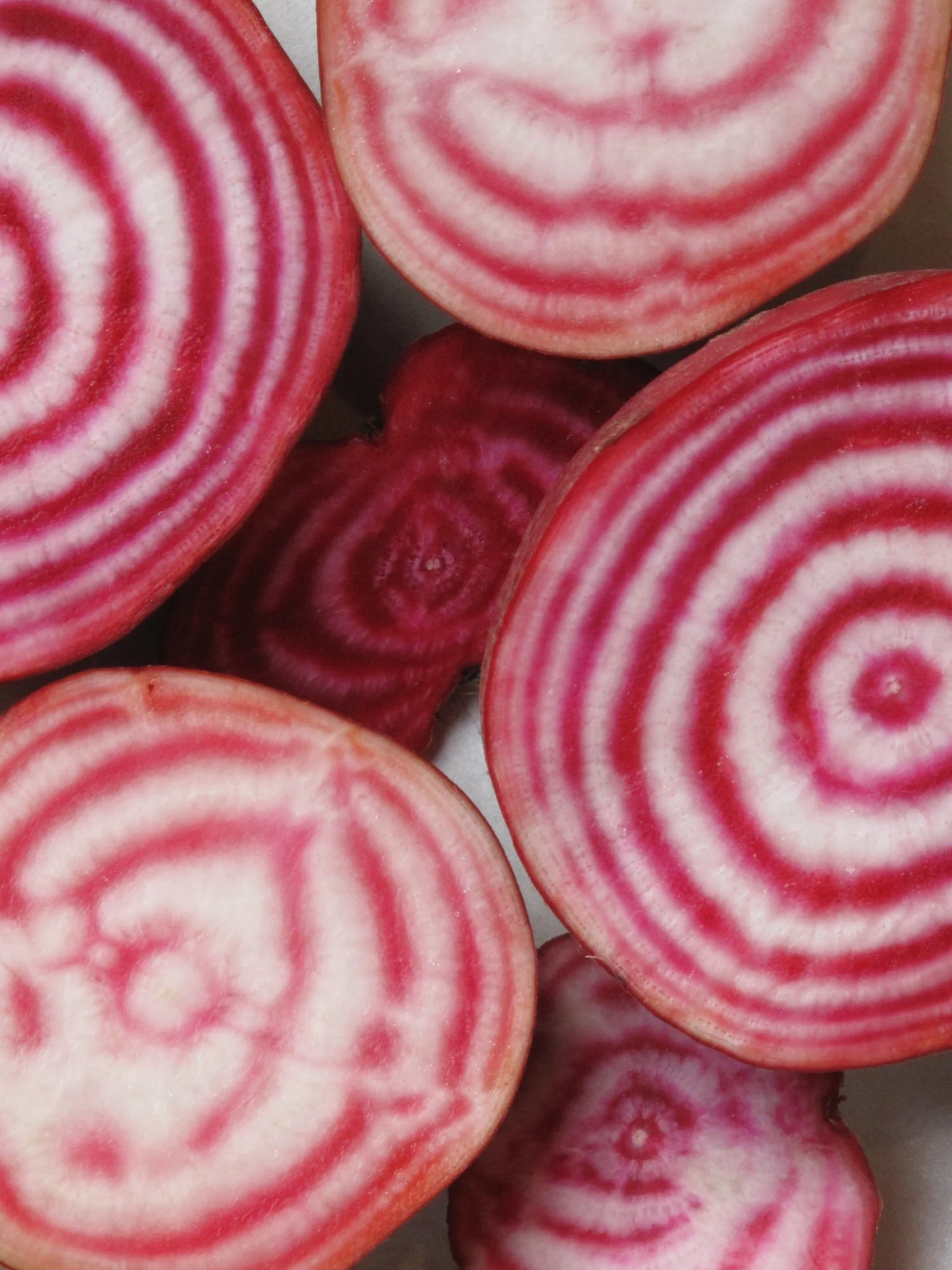 Close-up of beets with red and white swirls.