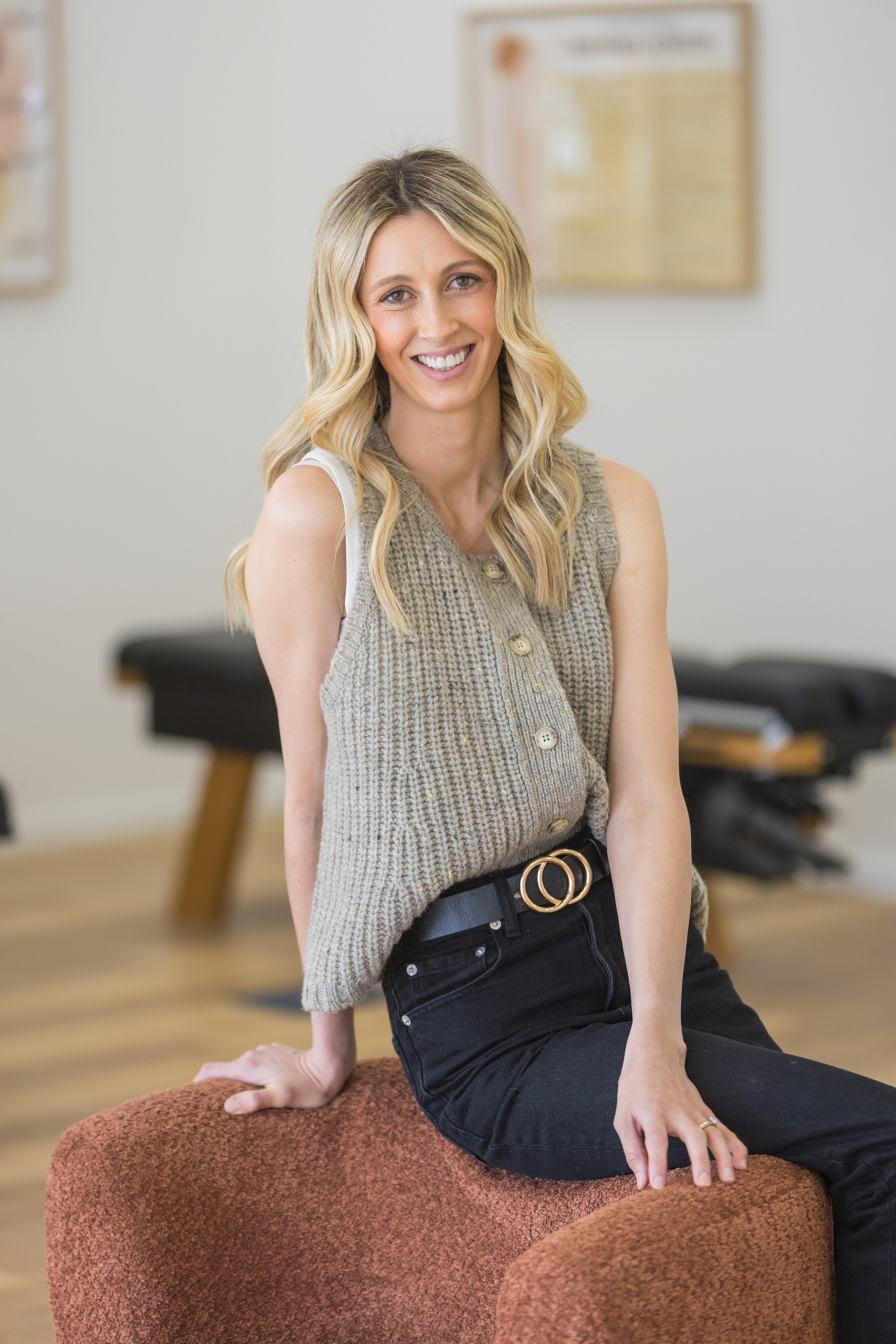 Chiropractor and Nutritionist Dr Elsie Rodgers-Rutledge - Owner of House of Healing Chiropractic Bendigo sitting on a chair in her clinic.