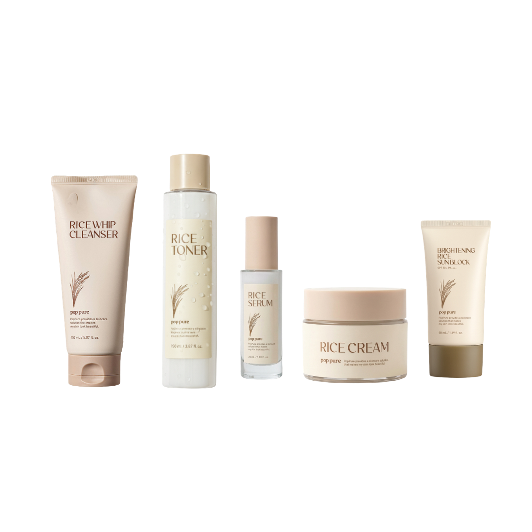 A collection of skincare products labeled Rice Whip Cleanser, Rice Toner, Rice Serum, Rice Cream, and Brightening Rice Sunblock on a white surface with a light background.