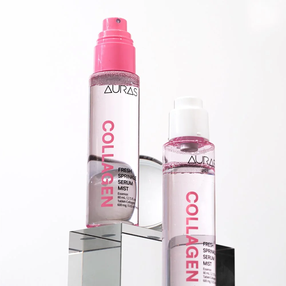 Two bottles of Aura Collagen Fresh Sprinkler Serum Mist on a reflective surface against a white background