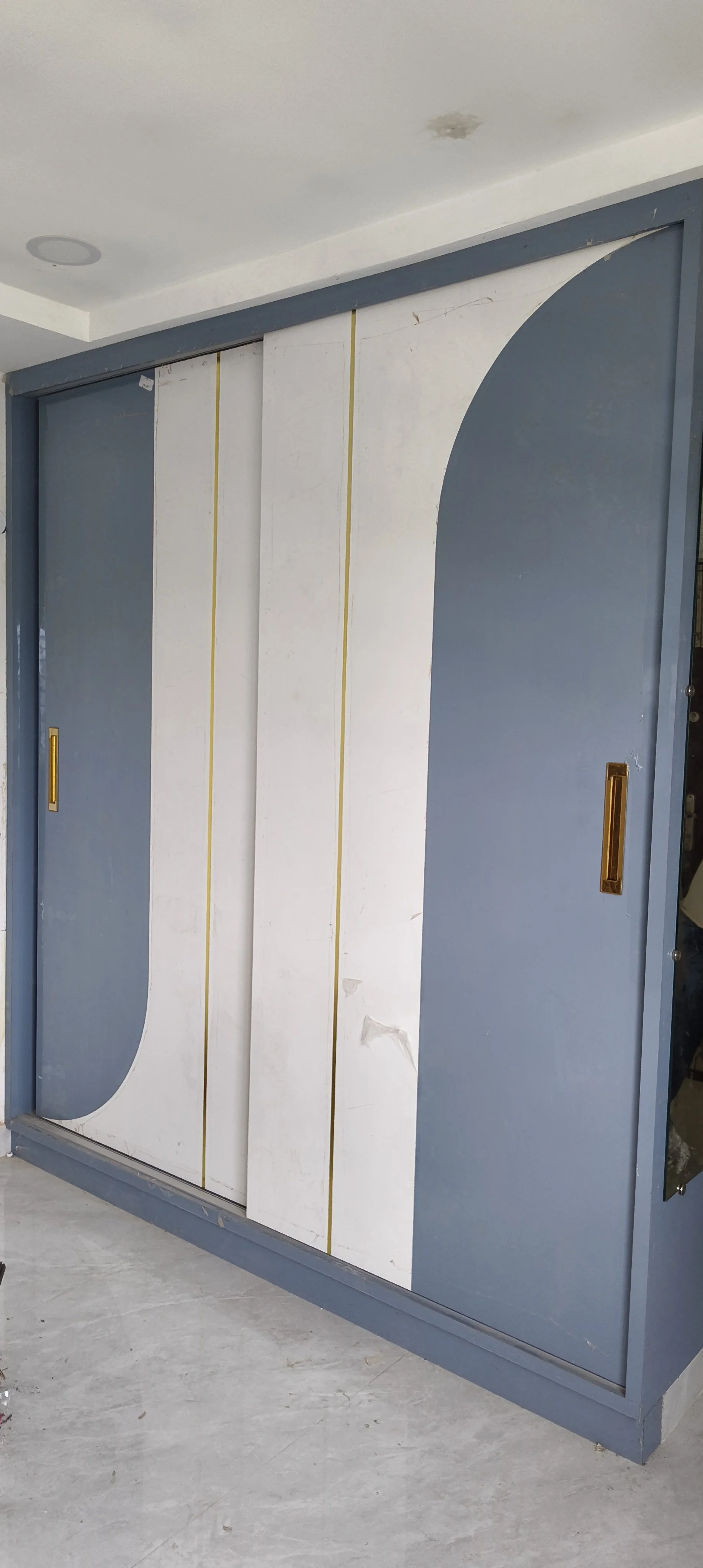 Modern sliding wardrobe door with high-gloss finish in Sri Nagar Colony, Khammam.