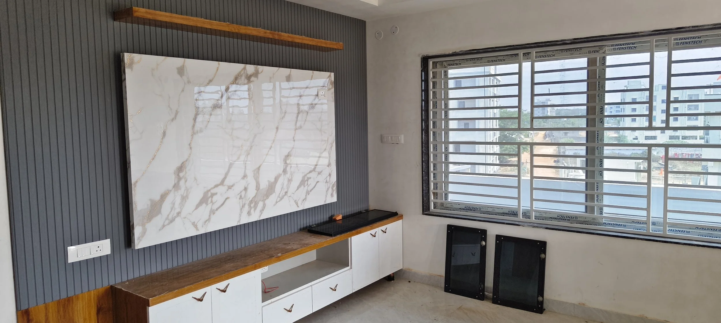 Modern TV unit design with LED profile lighting and wall panelling in Sri Nagar Colony Khammam.