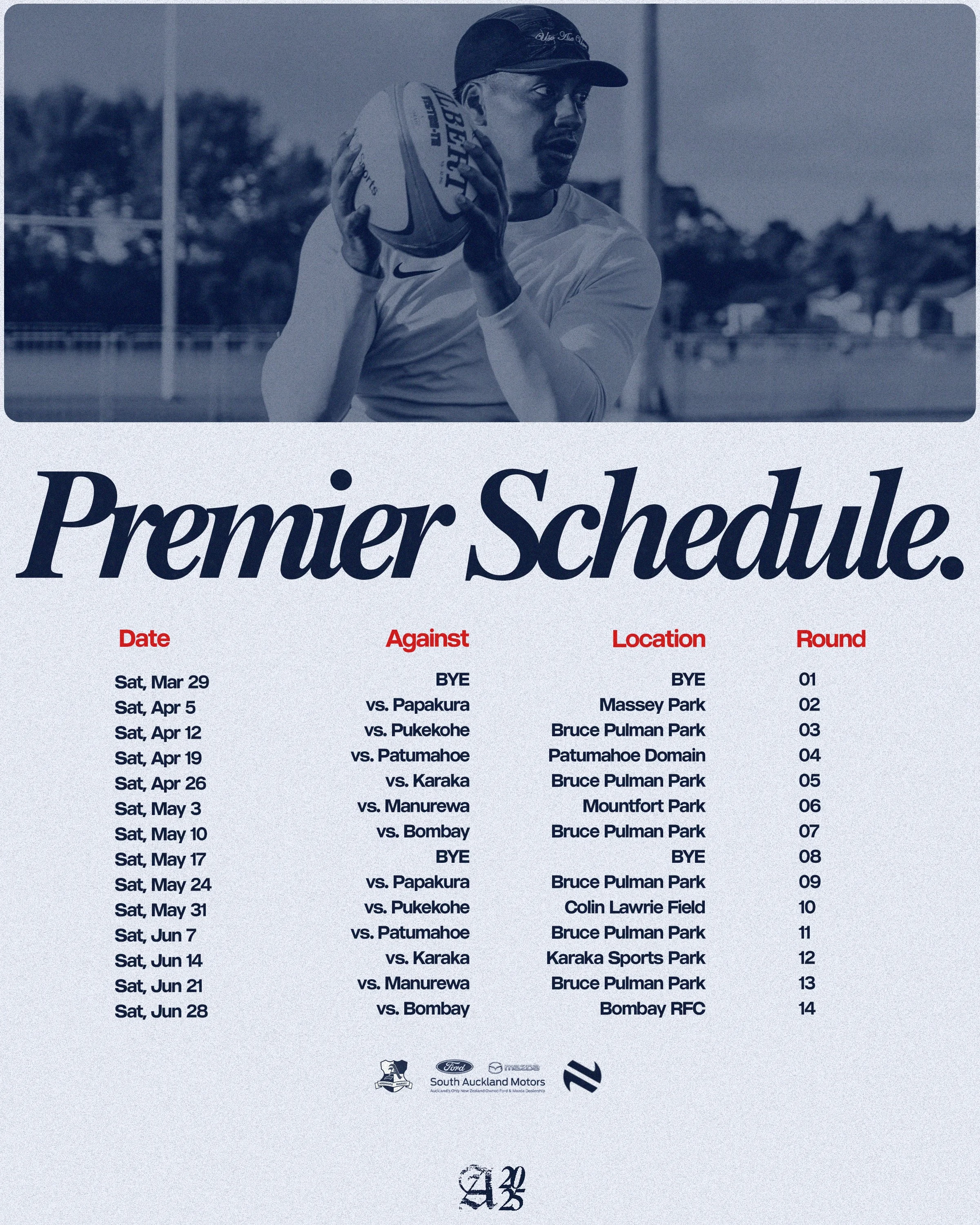 A rugby player holding a rugby ball, wearing a cap, during practice or a game at an outdoor rugby field with goal posts, trees, and buildings in the background. The image is in black and white with a blue tint.