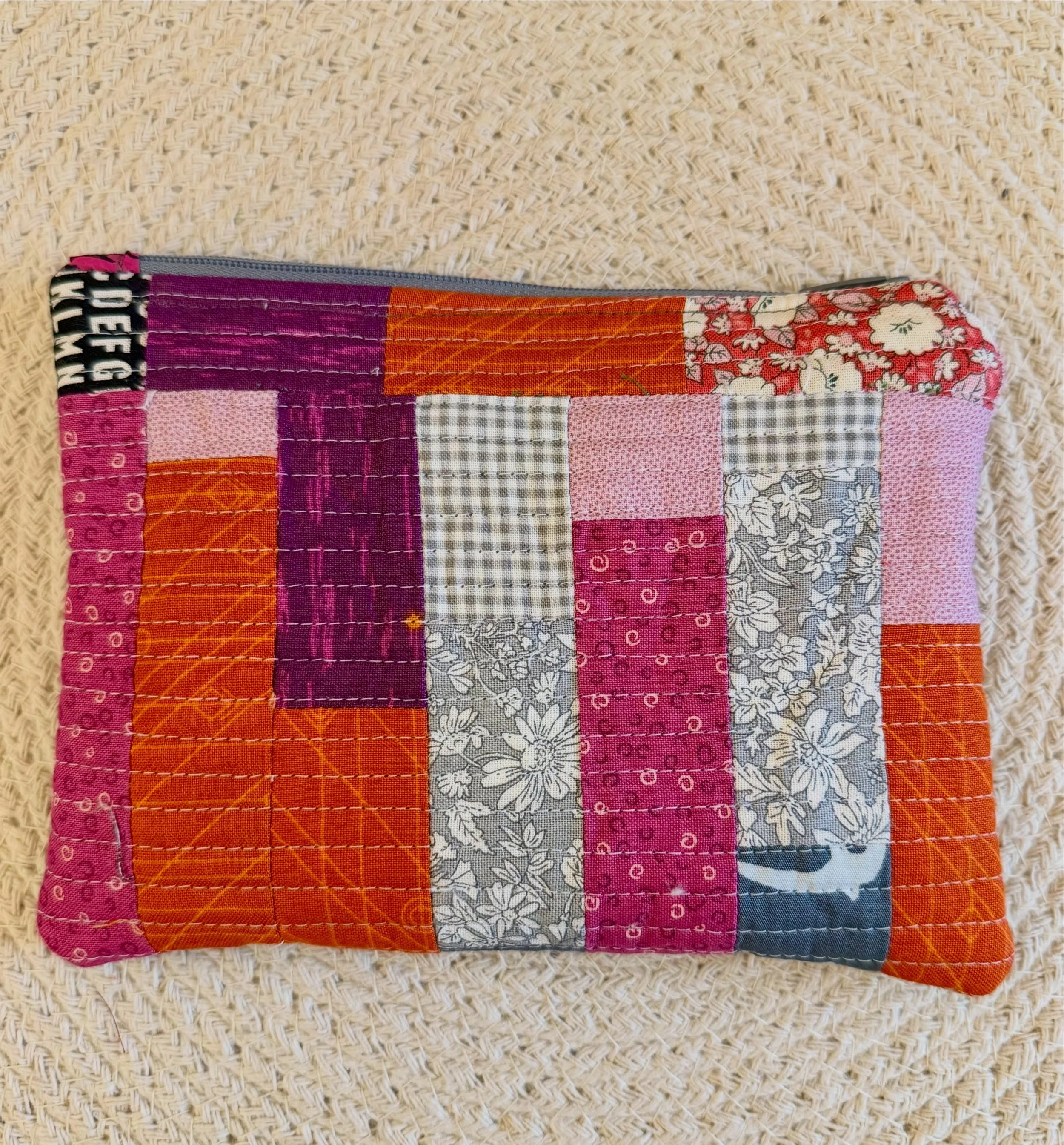 A little Friday night debut. 

I&rsquo;ve made patchwork pouches before, but I think this one deserves her own moment.

Pieced from small remnants in pink, orange, plum and grey, then closely quilted and paired with reclaimed denim on the reverse. In