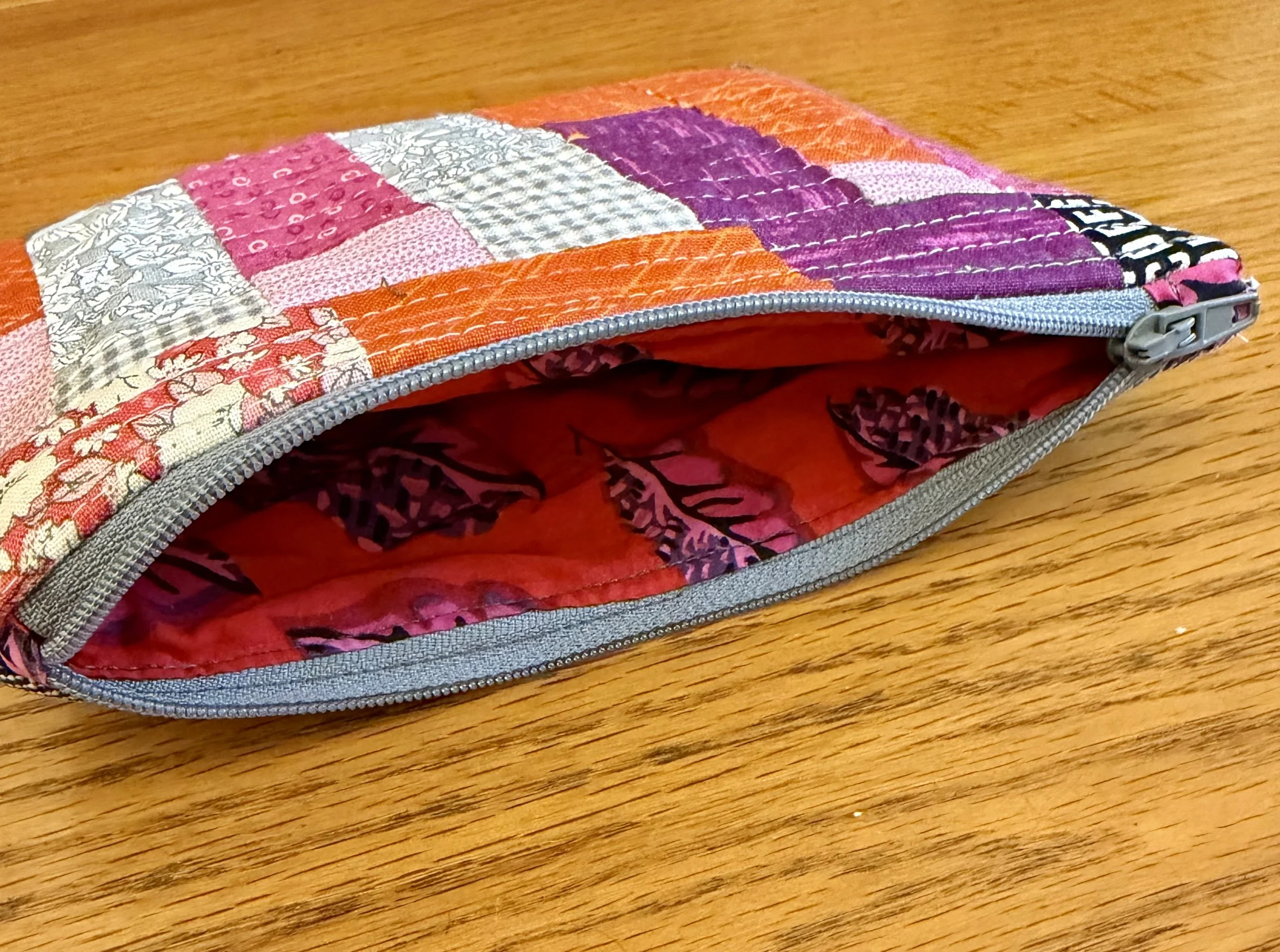Open Berry and Clementine patchwork pouch showing colourful patterned cotton lining