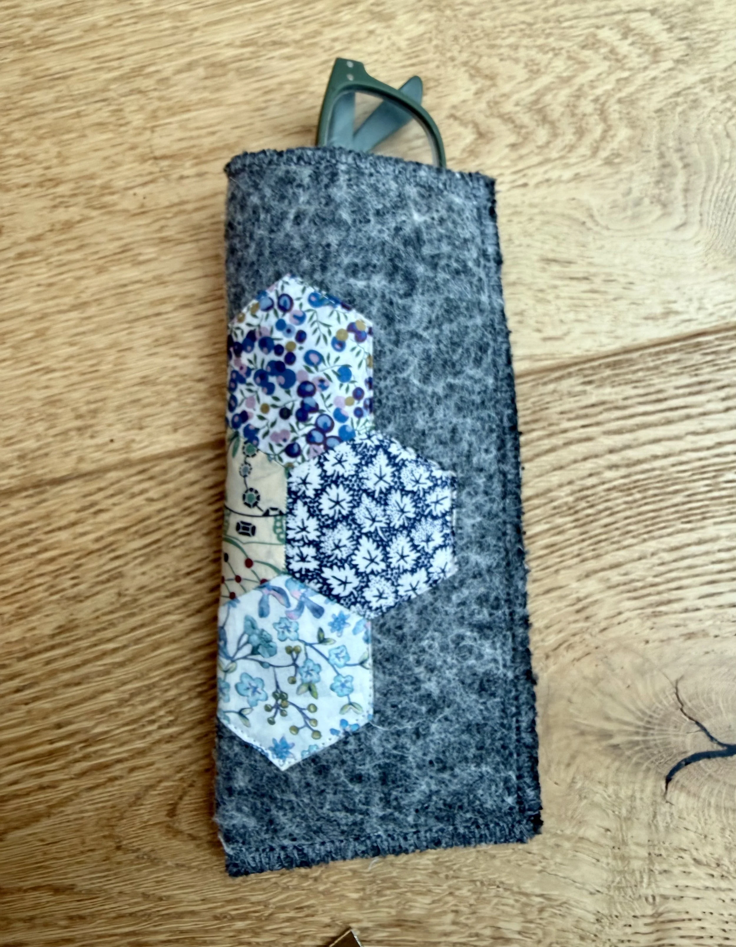 Grey wool Liberty Scrap Garden glasses case with blue floral patchwork and green glasses