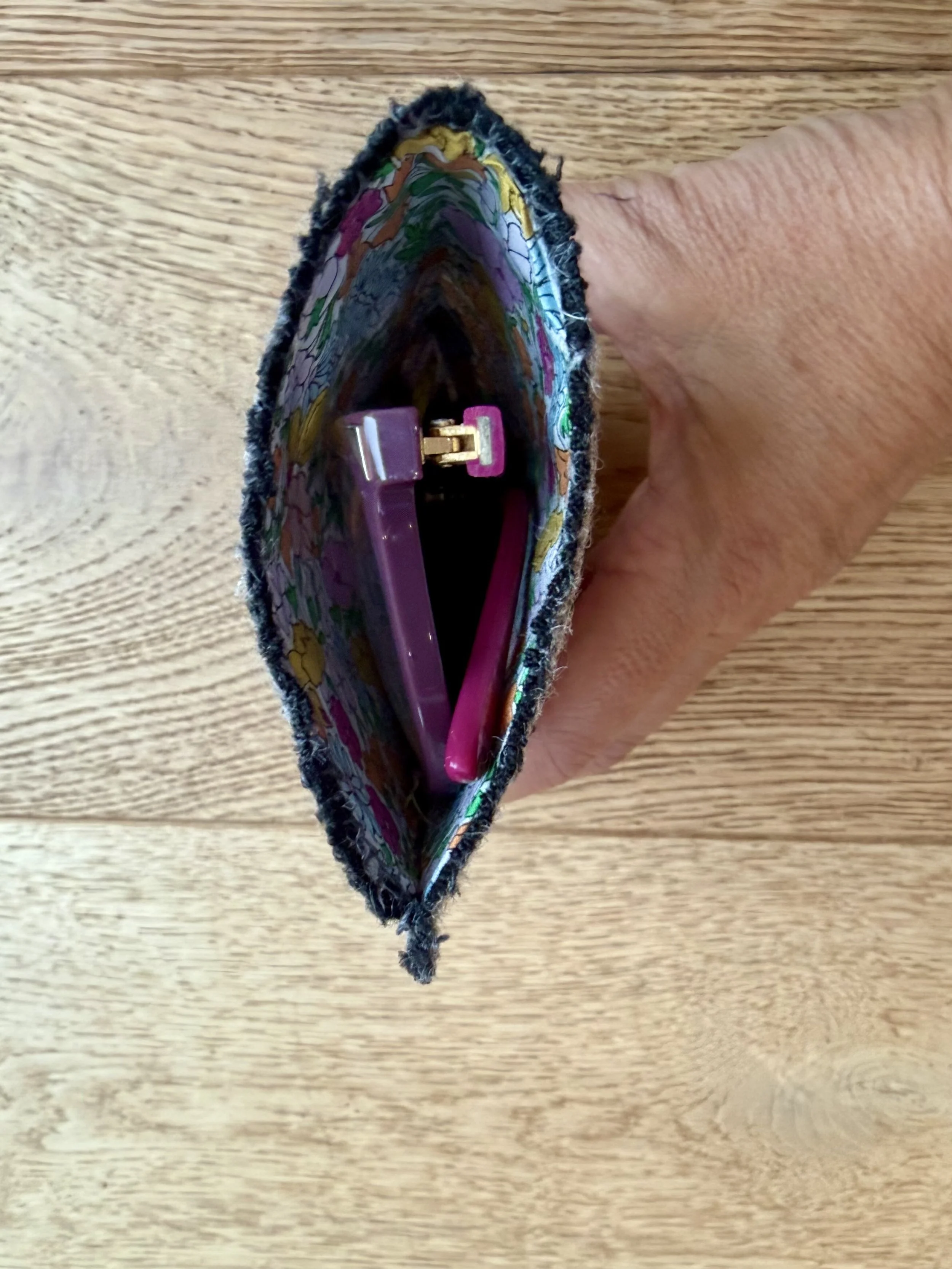 Liberty lined wool glasses case showing purple glasses inside