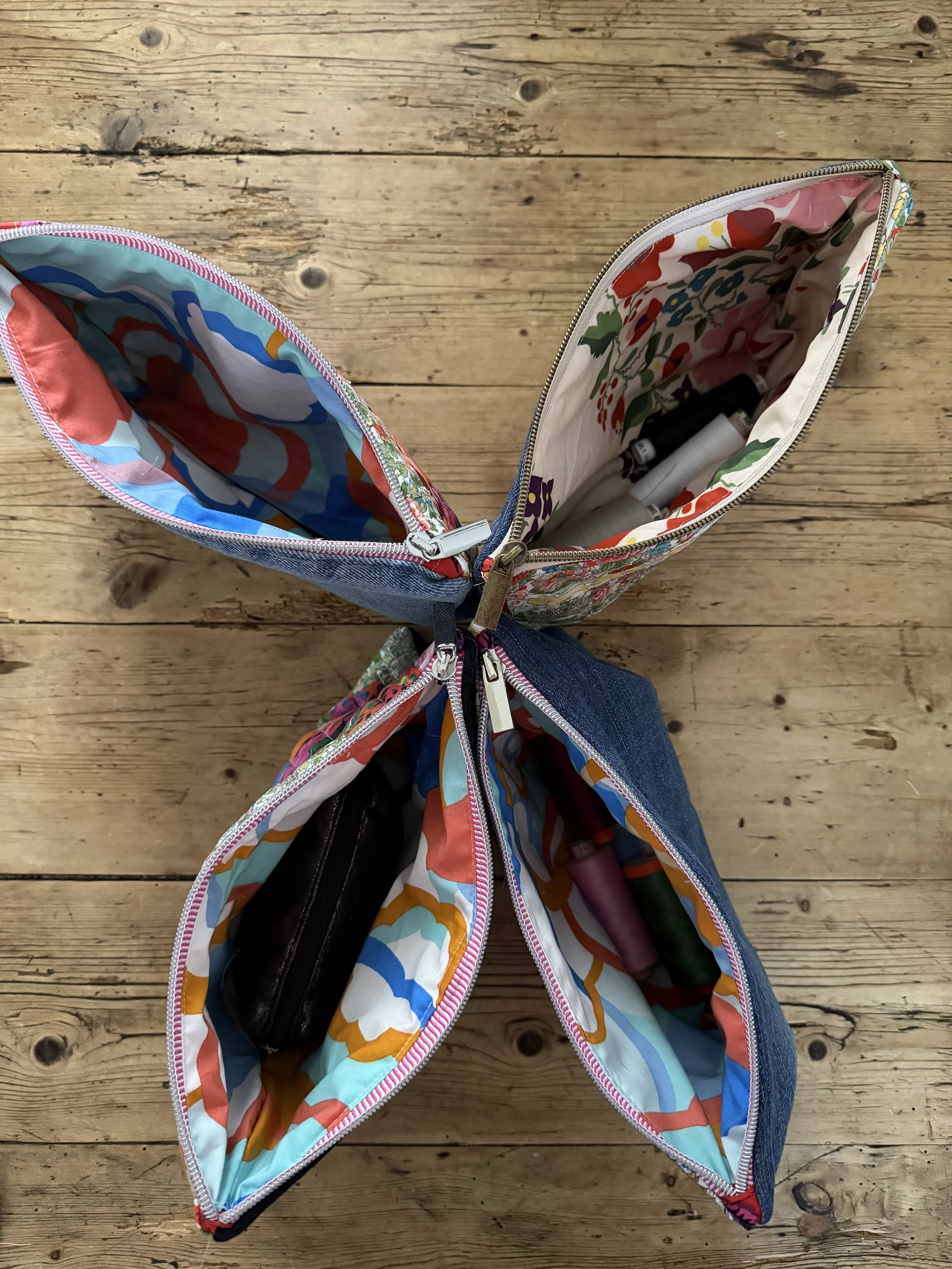 Open Tutti Fruitti patchwork pouches showing colourful floral and geometric cotton linings