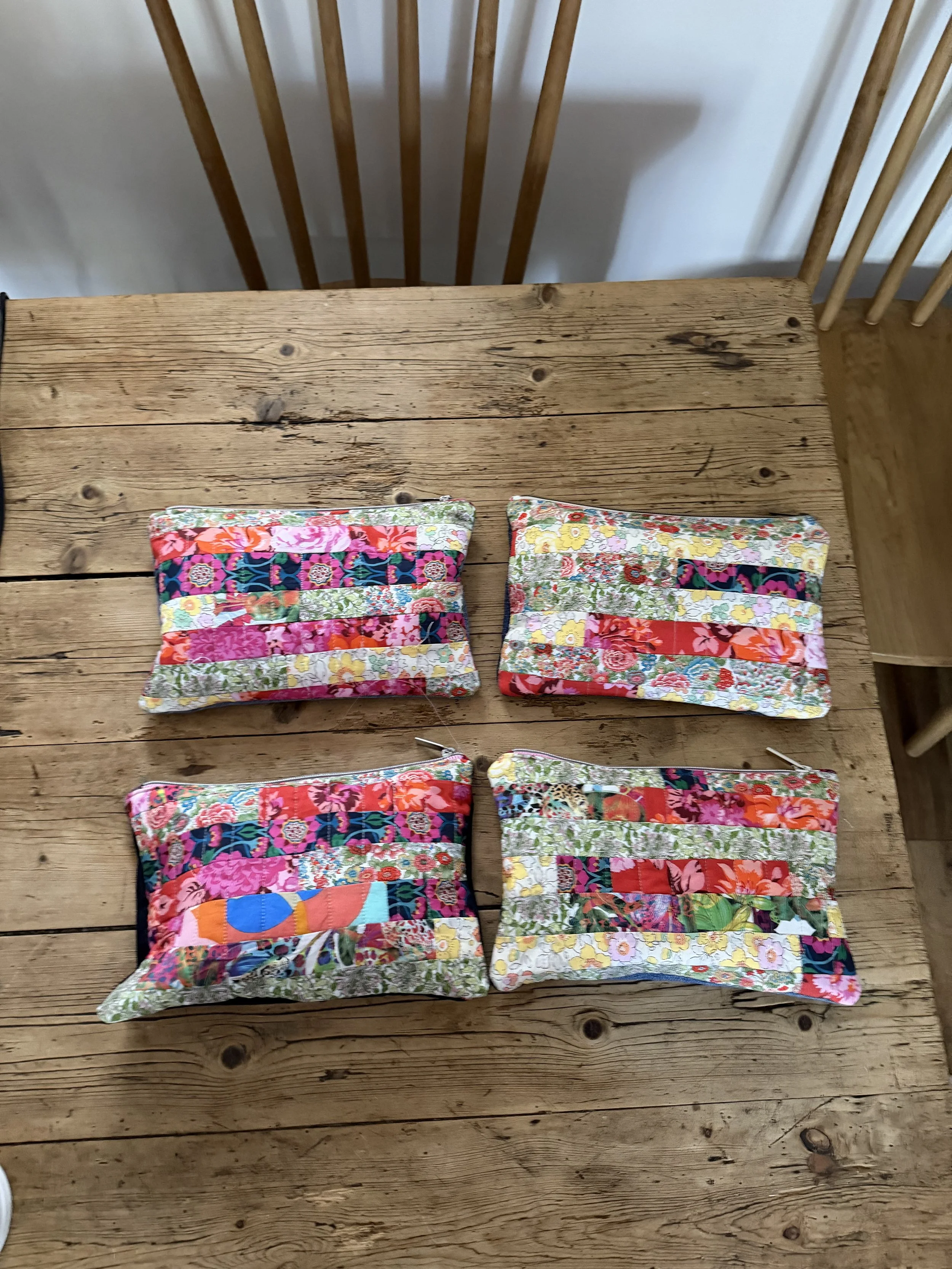 Four Tutti Fruitti Liberty patchwork pouches handmade from colourful fabric remnants