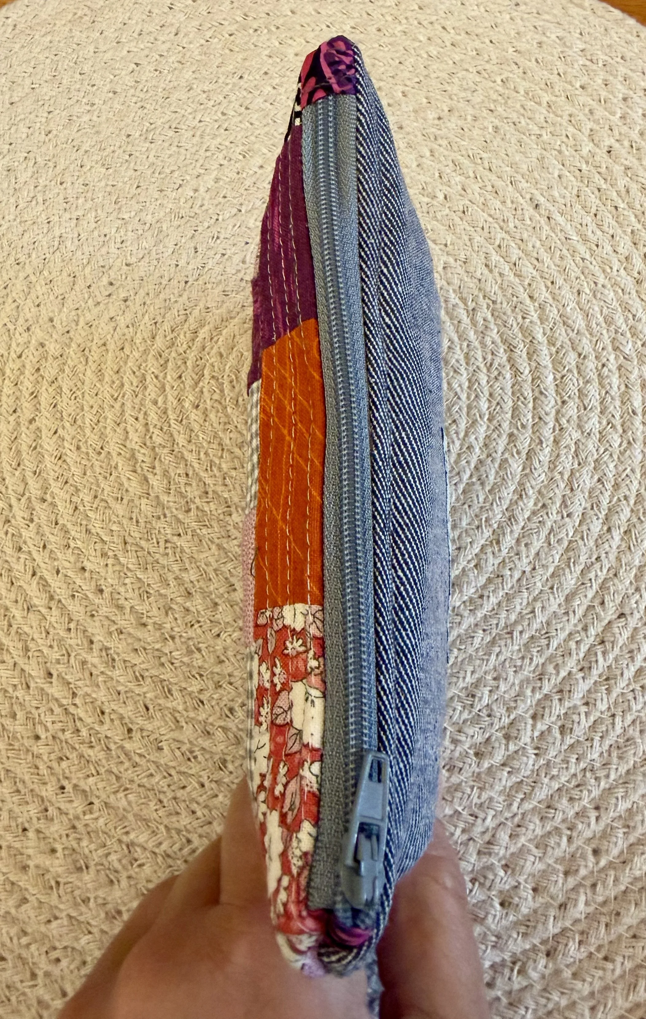 Side view of Berry and Clementine pouch showing grey zip and reclaimed denim back