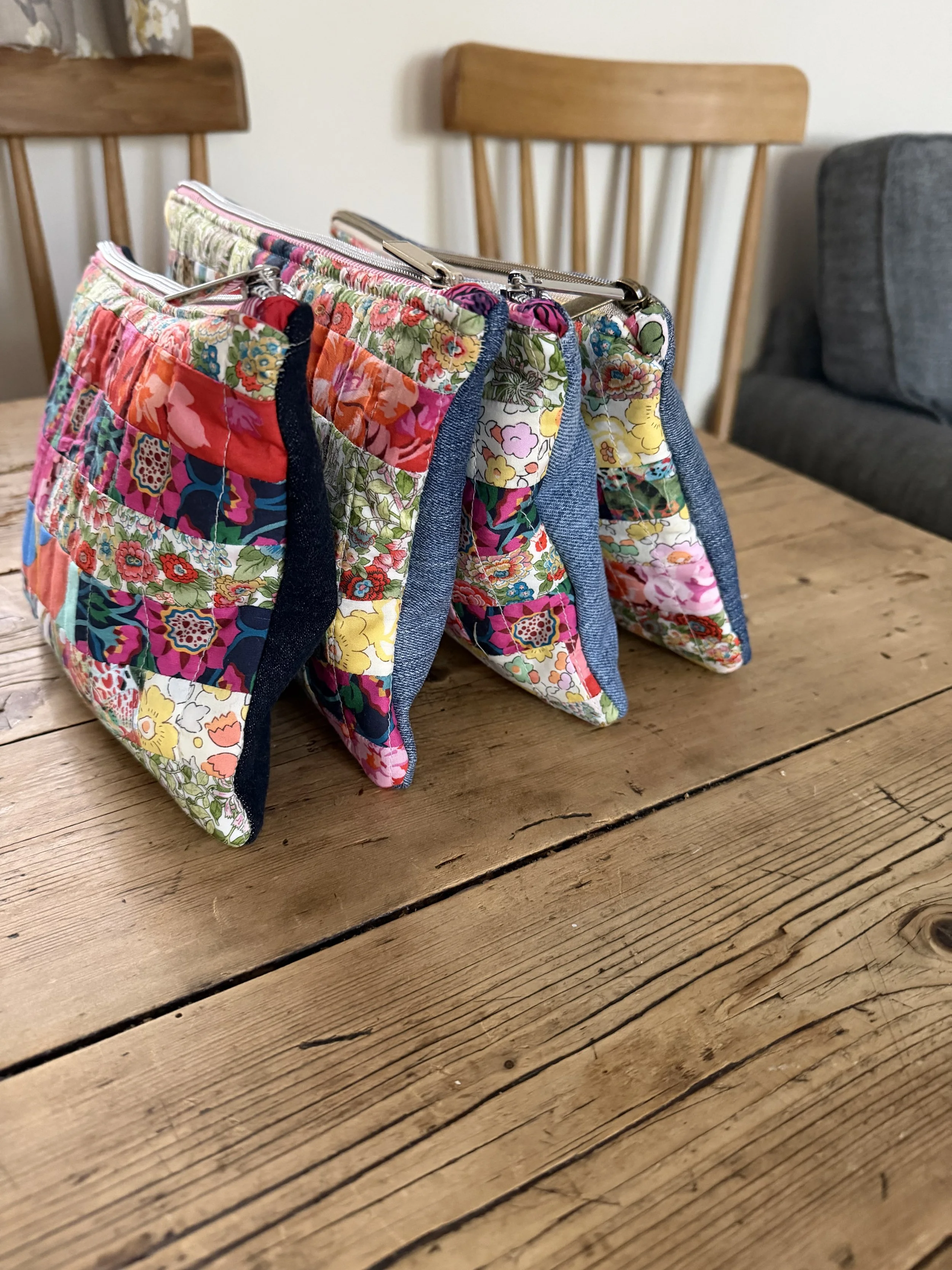 Tutti Fruitti patchwork pouches showing Liberty lawn fronts and reclaimed denim backs