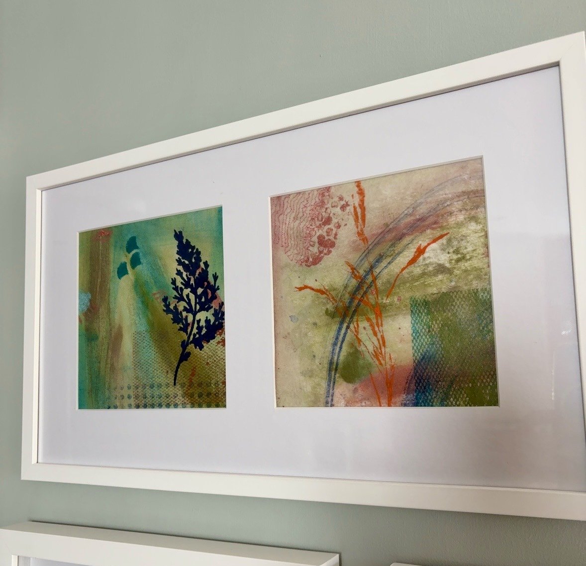 a framed pair of botanicals with dimensional fragments