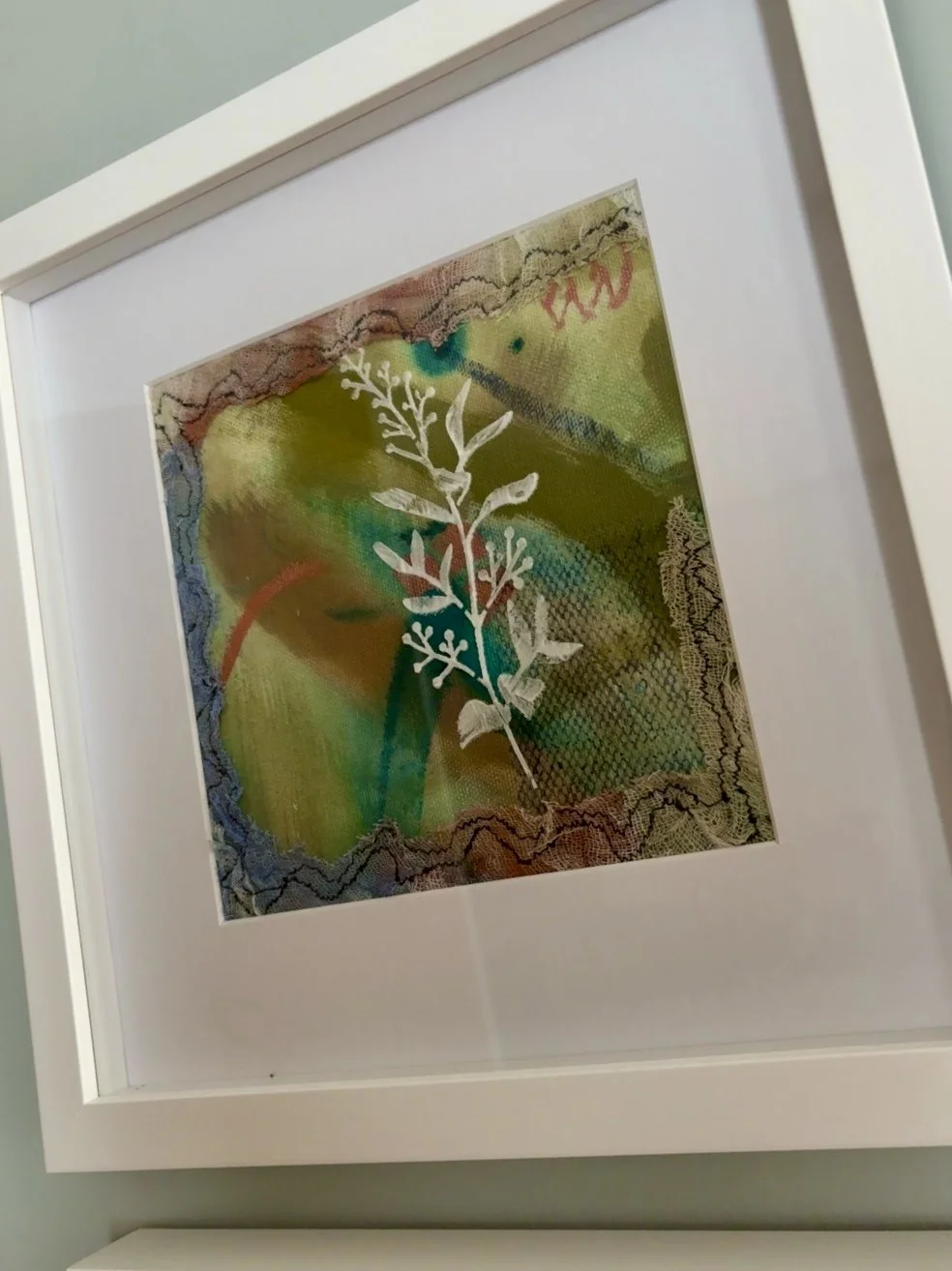 I painted a white botanical and stitched a lace border