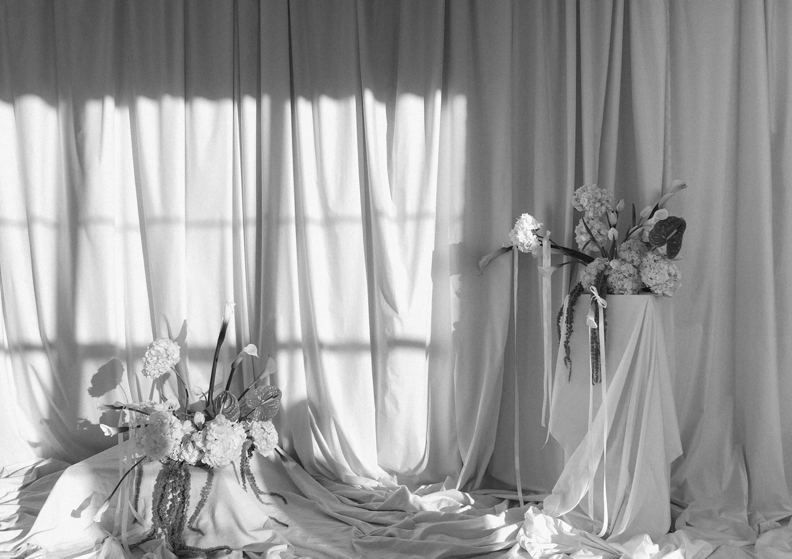 editorial branding shoot flowers maggie routon interior design studio the cottage rose full service wedding florist kansas city crossroads draped fabric ribbon calla lilies anthurium amaranth hydrangea pedestal flower arrangement