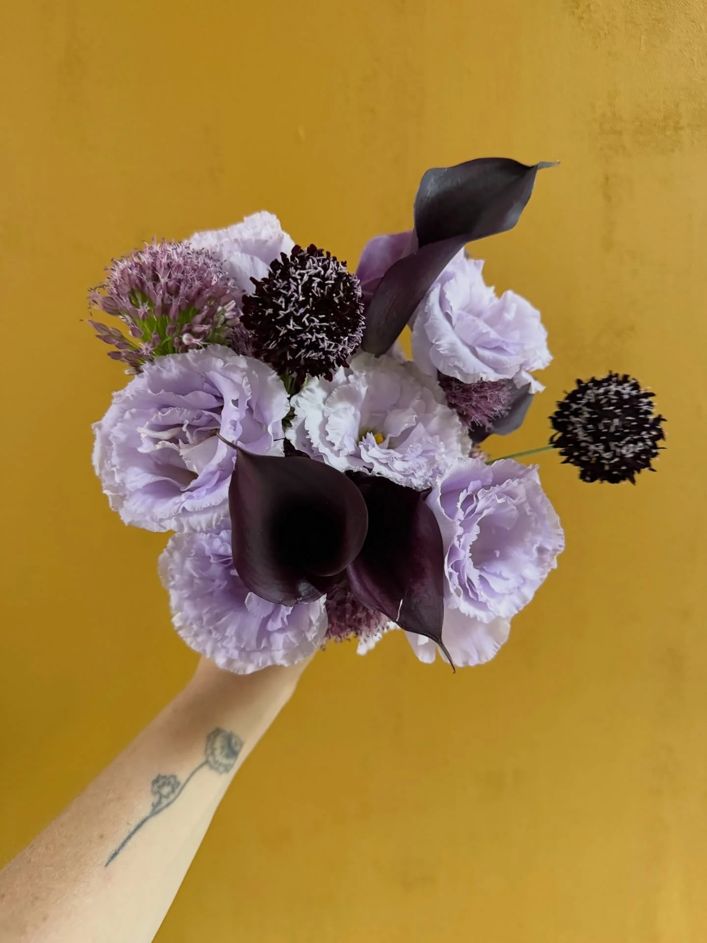 Petite purple ladies and a mustard yellow backdrop 💜💛 #thecottagerosebridalbouquet 
.
.
#thecottagerose | Kansas City wedding florist | destination wedding florist | custom florals | petite wedding bouquet | summer wedding inspiration | editorial f
