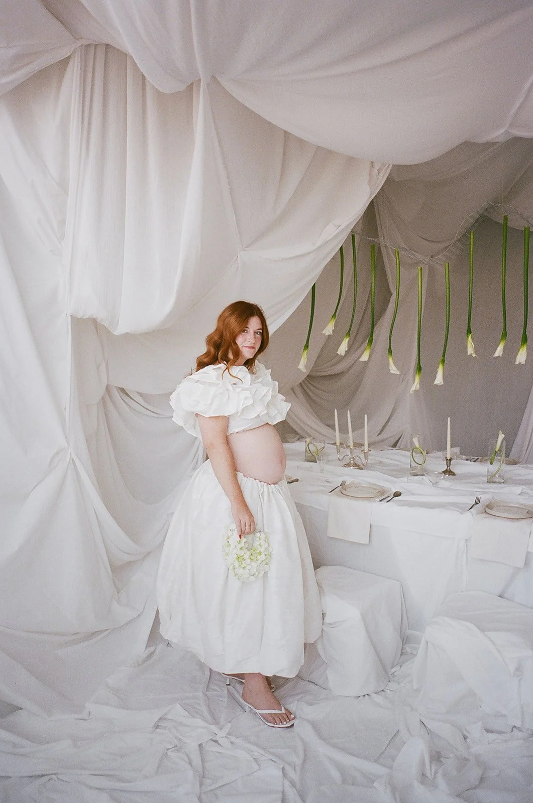 chic editorial baby shower with draped fabric hanging calla lilies minimal architectural centerpieces silver candlesticks the cottage rose full service wedding florist kansas city crossroads modern floral design orchid floral purse
