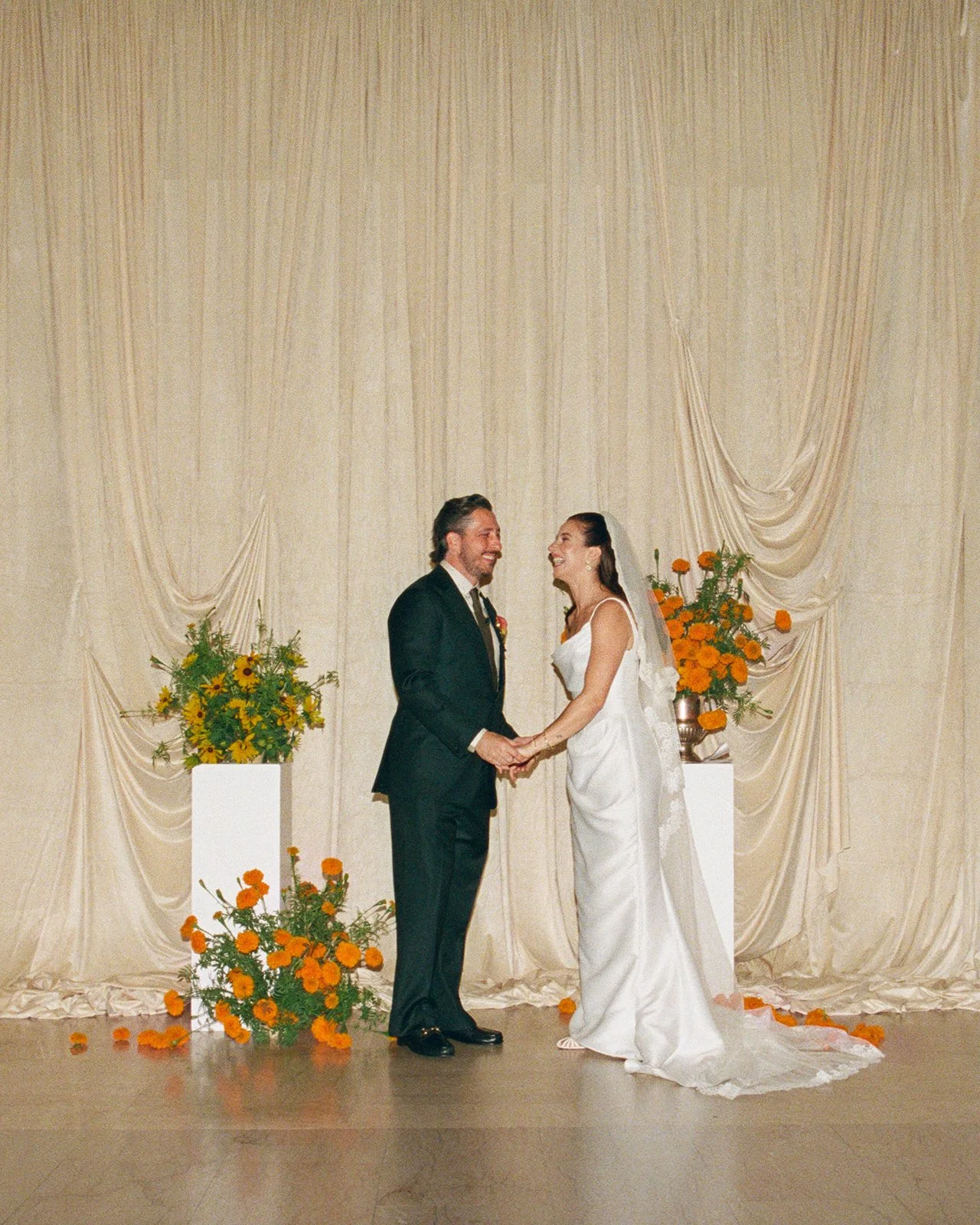September wedding at Hotel Kansas City mango calla lilies marigolds craspedia the cottage rose full service wedding florist crossroads modern wedding flowers pedestal flowers ceremony altar installation draped fabric
