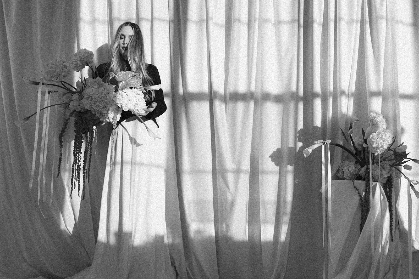 editorial branding shoot flowers maggie routon interior design studio the cottage rose full service wedding florist kansas city crossroads draped fabric ribbon calla lilies anthurium amaranth hydrangea pedestal flower arrangement