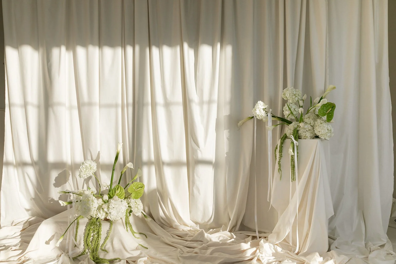 editorial branding shoot flowers maggie routon interior design studio the cottage rose full service wedding florist kansas city crossroads draped fabric ribbon calla lilies anthurium amaranth hydrangea pedestal flower arrangement