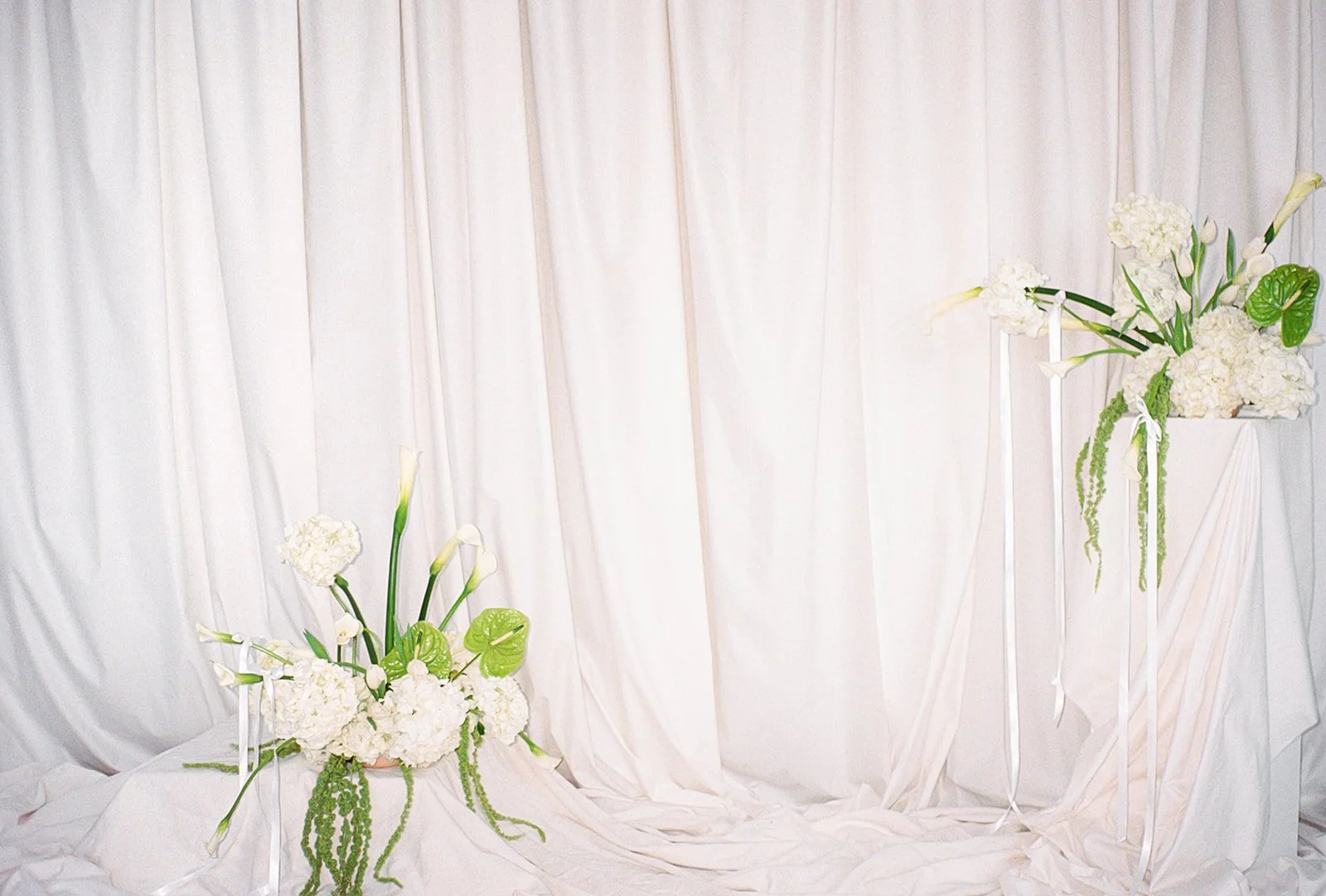 editorial branding shoot flowers maggie routon interior design studio the cottage rose full service wedding florist kansas city crossroads draped fabric ribbon calla lilies anthurium amaranth hydrangea pedestal flower arrangement