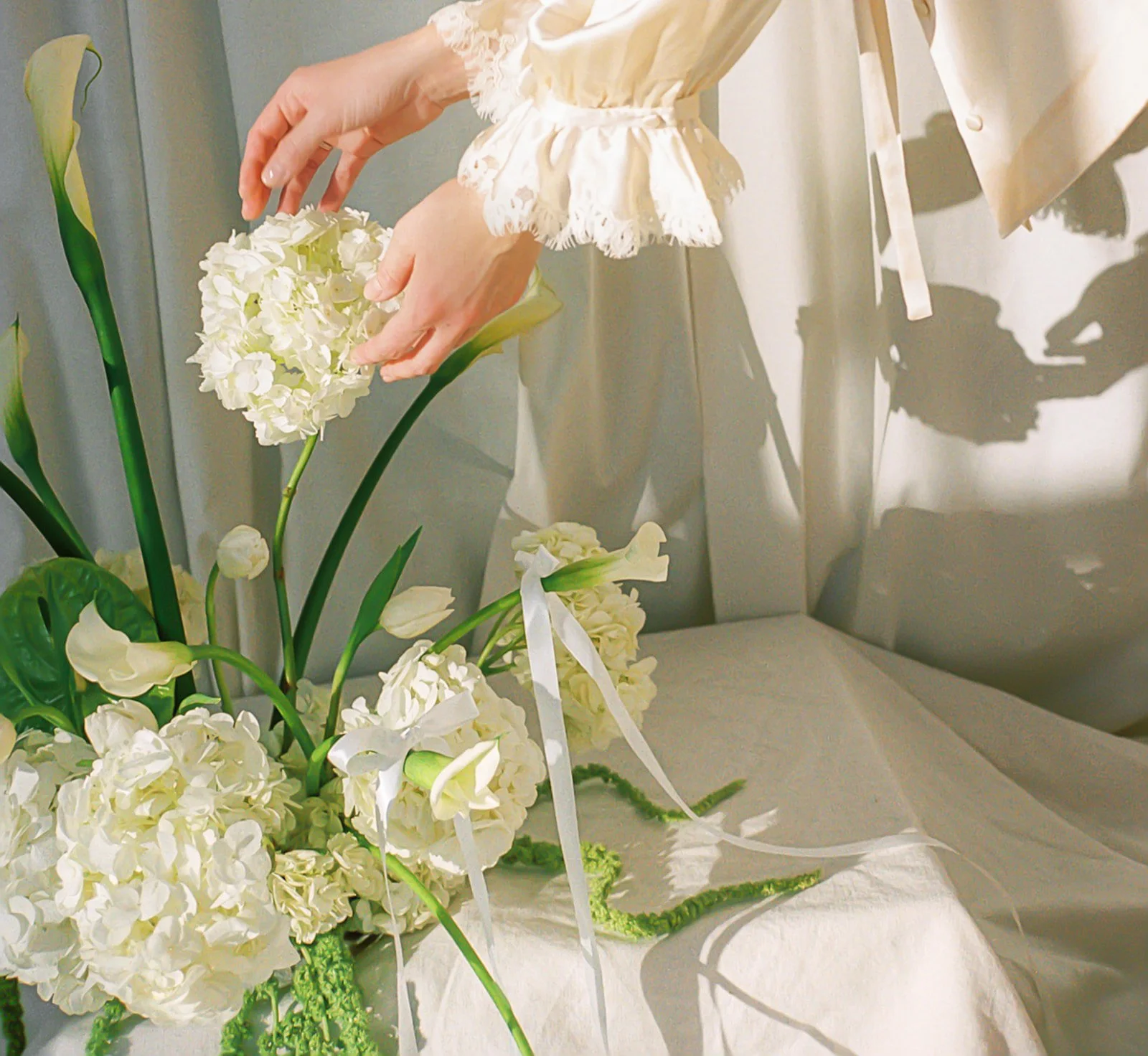 editorial branding shoot flowers maggie routon interior design studio the cottage rose full service wedding florist kansas city crossroads draped fabric ribbon calla lilies anthurium amaranth hydrangea pedestal flower arrangement