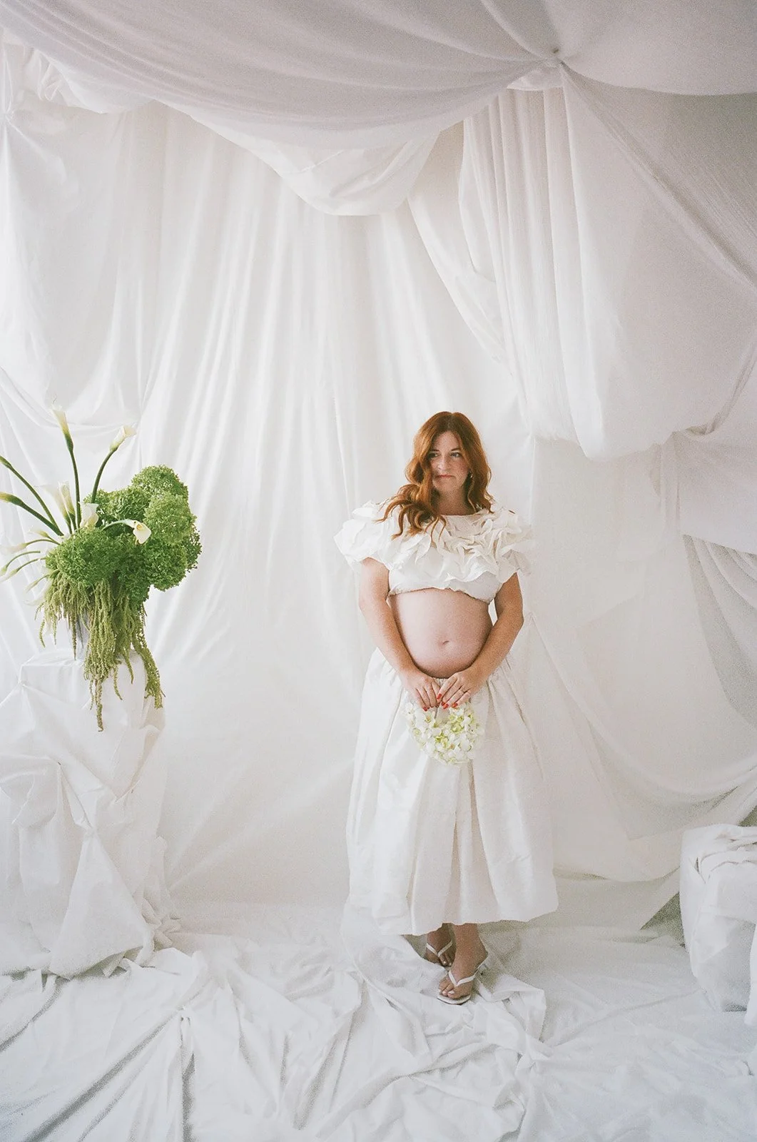 chic editorial baby shower with draped fabric hanging calla lilies minimal architectural centerpieces silver vase the cottage rose full service wedding florist kansas city crossroads modern floral design hydrangea amaranth arrangement orchid purse