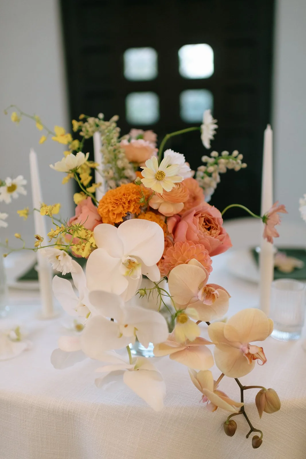 colorful fall wedding at la villa midtown kansas city the cottage rose full service wedding florist crossroads orchid ceremony hanging archway flowers marigolds modern florals sweetheart table decor bridal bouquet