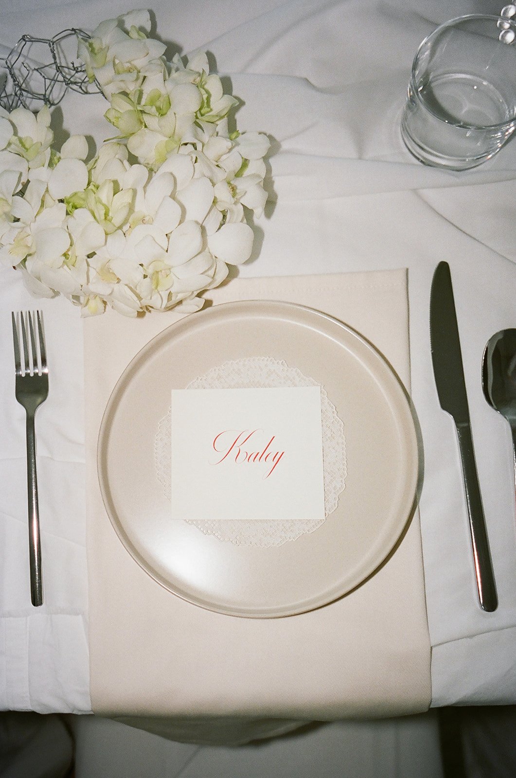 chic editorial baby shower with draped fabric hanging calla lilies minimal architectural centerpieces silver vase the cottage rose full service wedding florist kansas city crossroads modern floral design hydrangea amaranth arrangement orchid purse