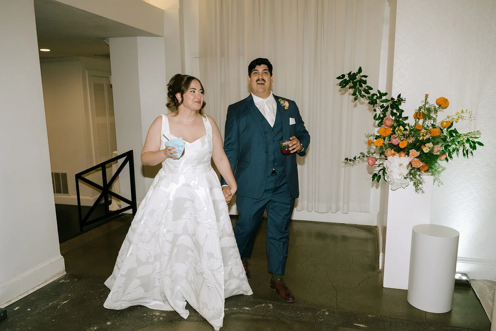 colorful fall wedding at la villa midtown kansas city the cottage rose full service wedding florist crossroads orchid ceremony hanging archway flowers marigolds modern florals lounge furniture florals