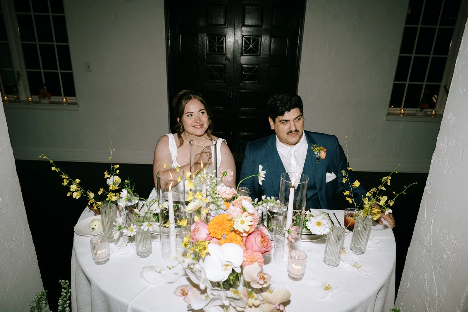 colorful fall wedding at la villa midtown kansas city the cottage rose full service wedding florist crossroads orchid ceremony hanging archway flowers marigolds modern florals sweetheart table decor bud vase centerpieces
