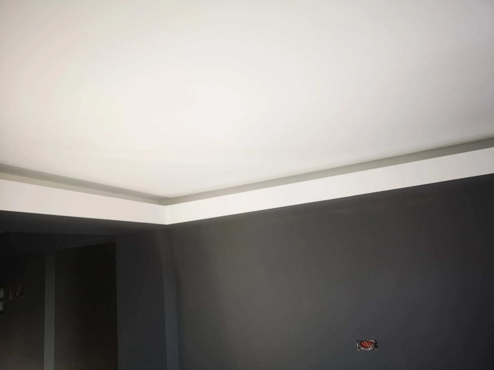 Ceiling with recessed lighting and partially visible walls painted in shades of gray.