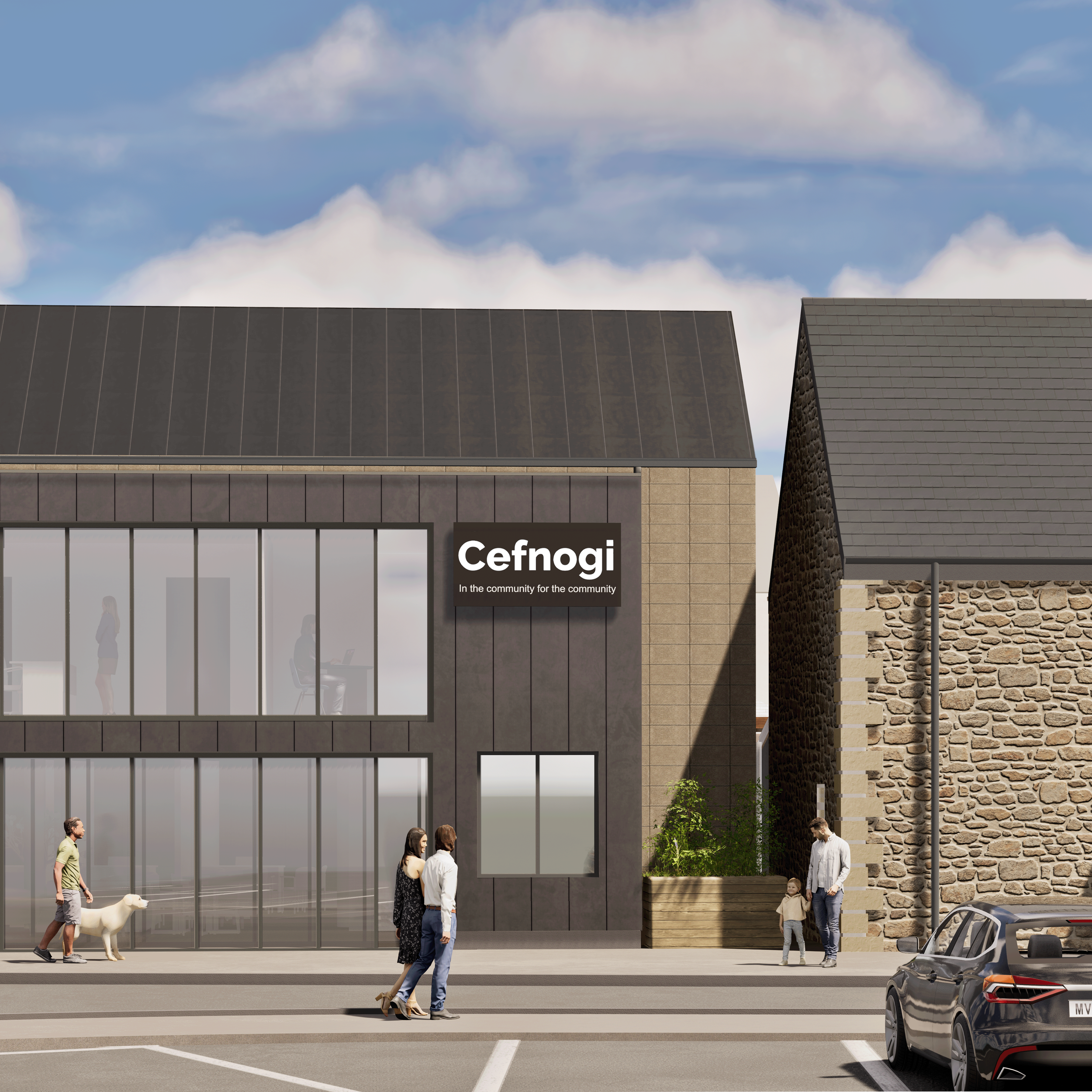 Modern two-storey community building with dark metal exterior and large windows. Sign reads “Cefnogi – In the community for the community.” People walk by; car parked under a partly cloudy sky.