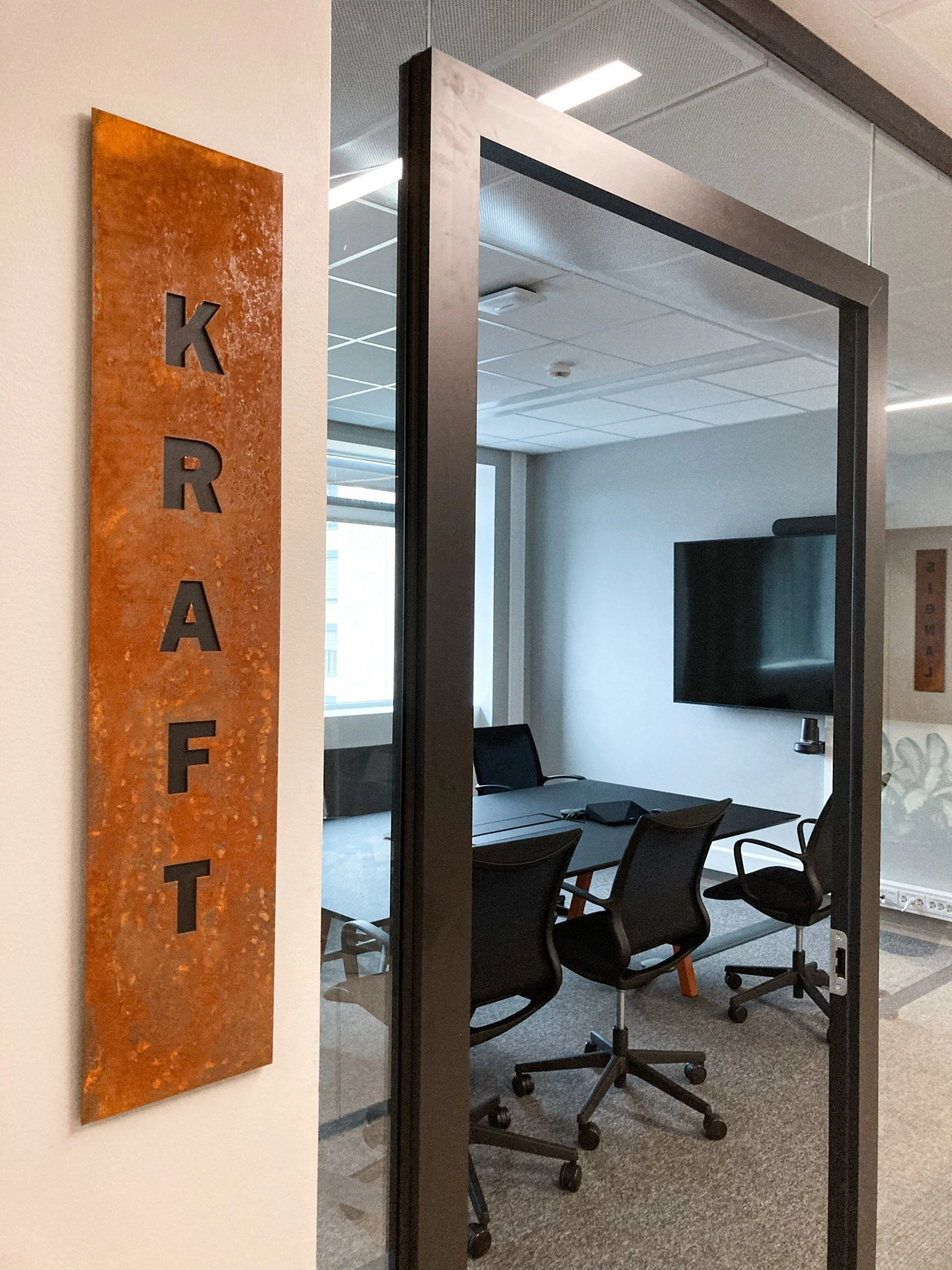 Møterommet KRAFT med navneskilt i cortenstål med utskåret skrift, Spordrift