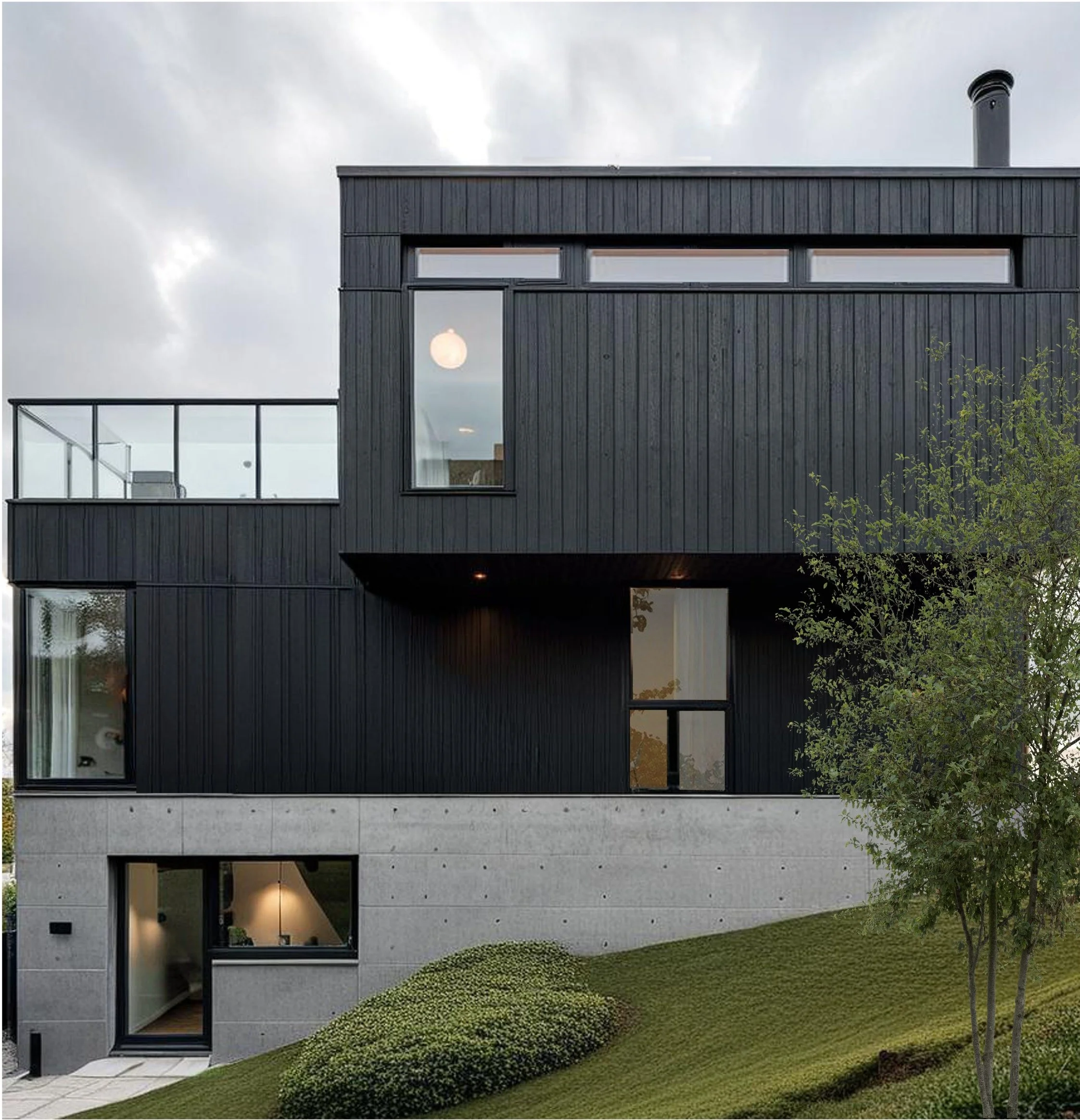 Modern multi-story house with dark exterior, large windows, and a small front yard with green grass and bushes.