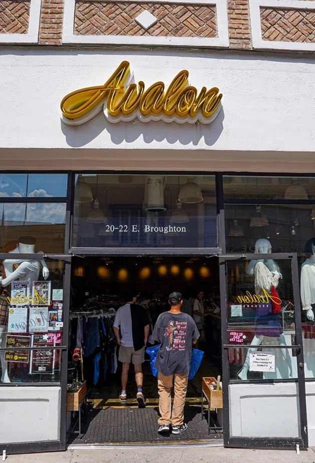 A person enters Avalon, a clothing store with mannequins and racks inside, located at 20-22 E. Broughton.