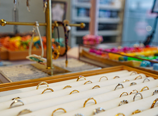 Jewelry display with rings and bracelets on a table in a store.