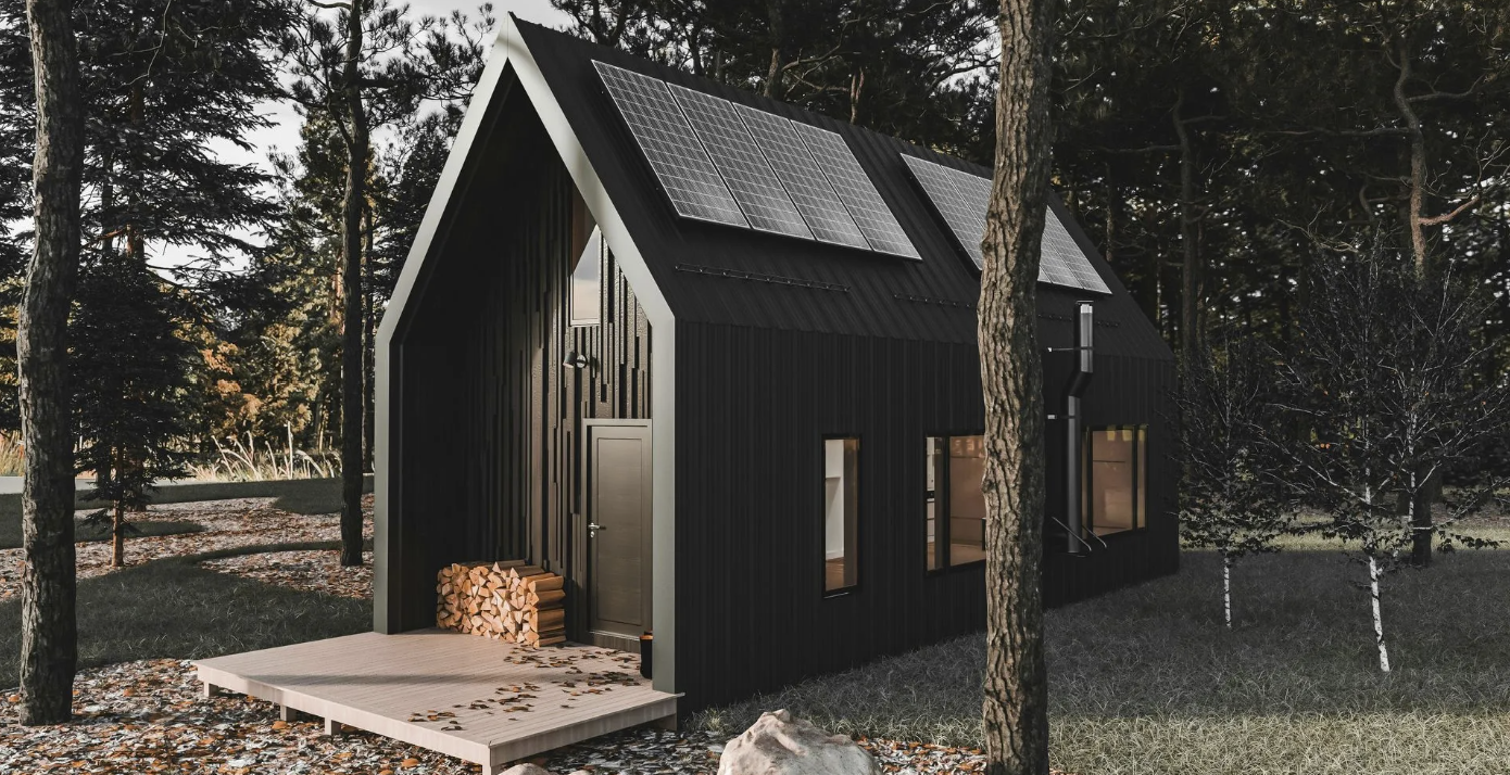 a dark brown tiny-home adu with a peaked roof and solar panels and a stack of wood by the front door