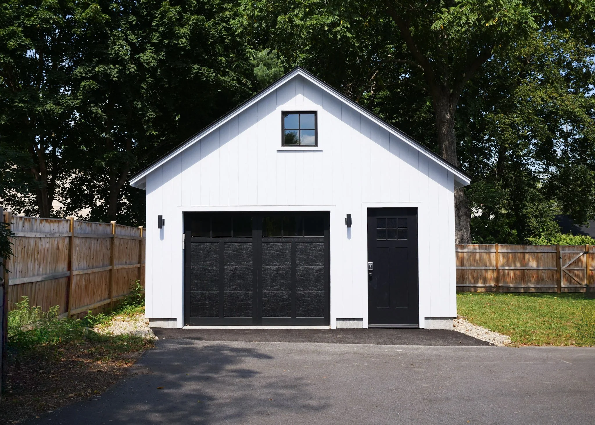 facade of white single-car garage with black doors