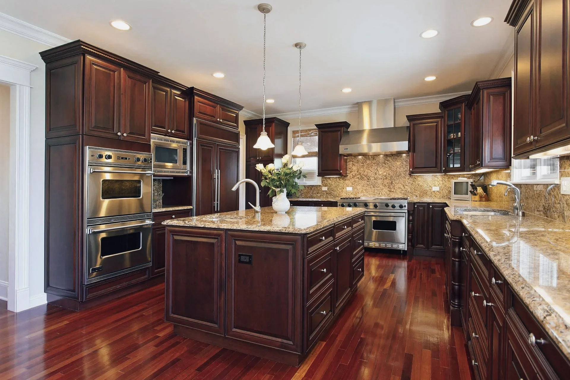 kitchen with dark cherry cabinets and floors, warm brown marble counter tops