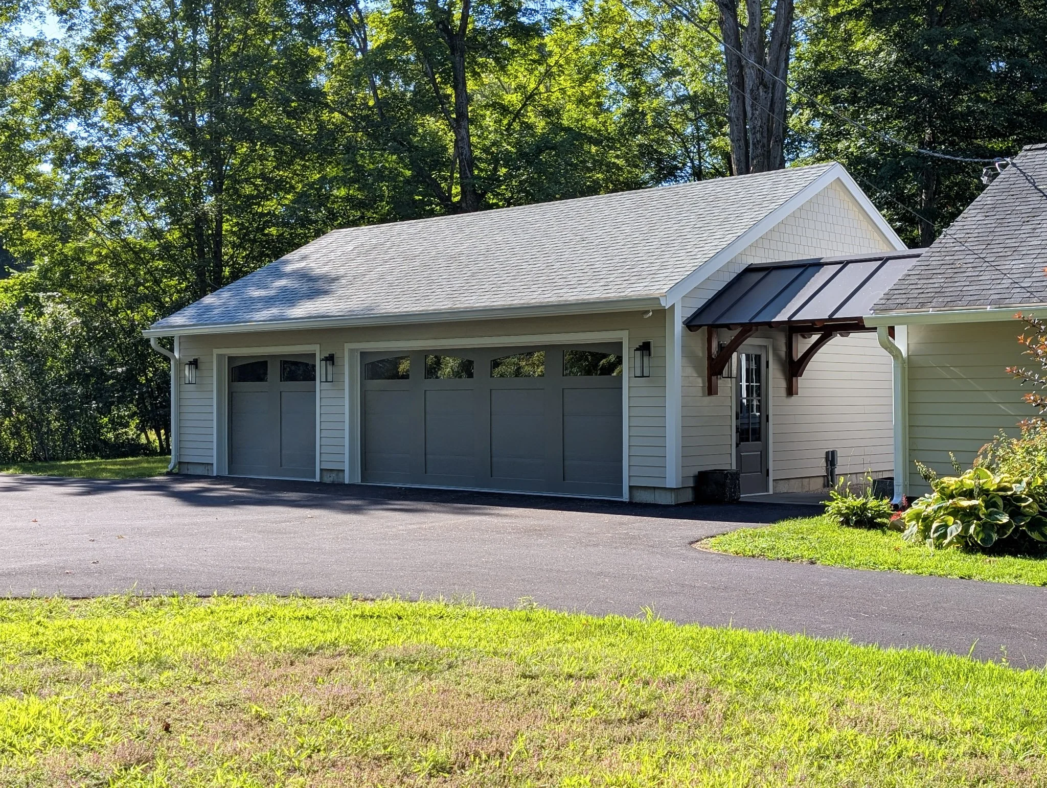 tan garage with two grey carports