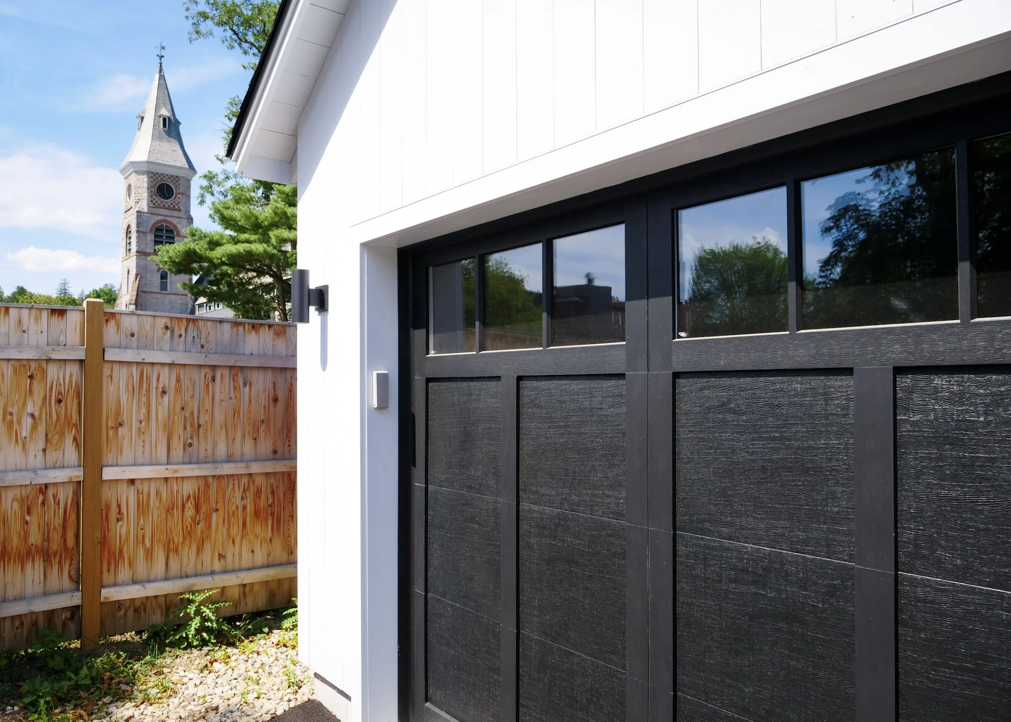 close-up view of a white garage with black doors