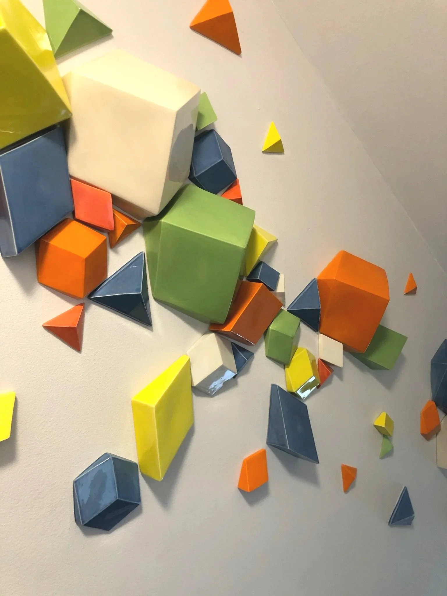 colourful ceramic shapes wall installation by CWCCeramics