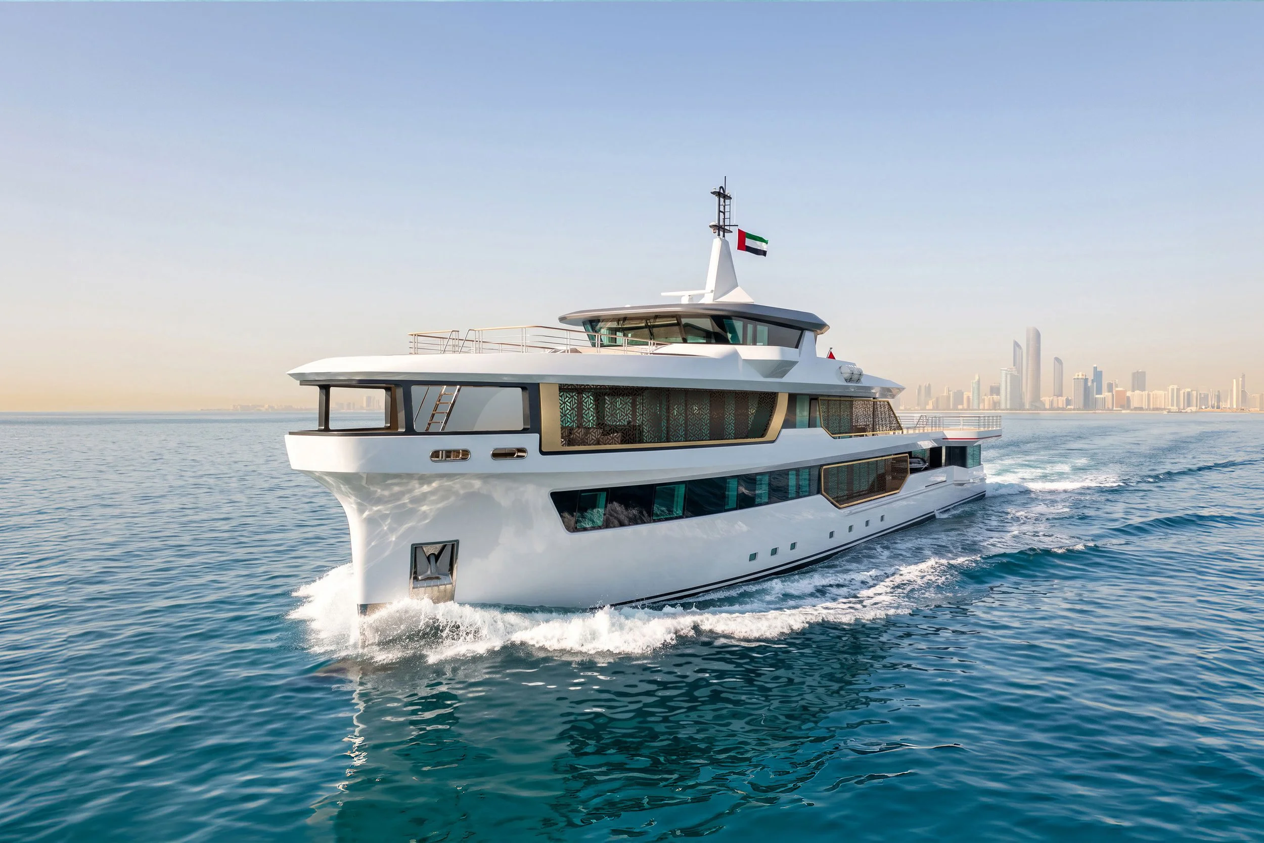 A modern white yacht sailing on the water with a city skyline in the background during the daytime.