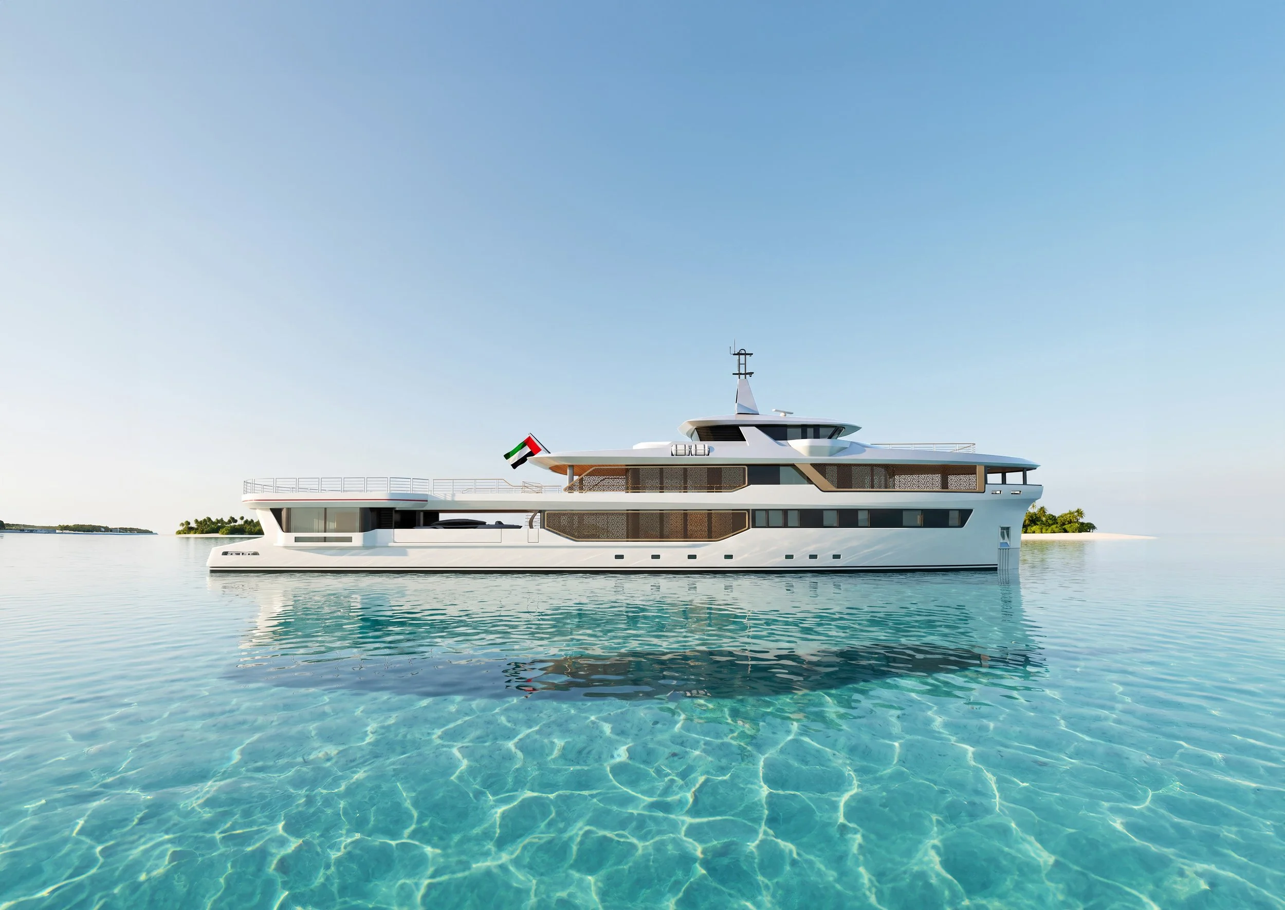A modern white yacht floating on calm, clear water with a small strip of land and trees in the background against a clear blue sky.