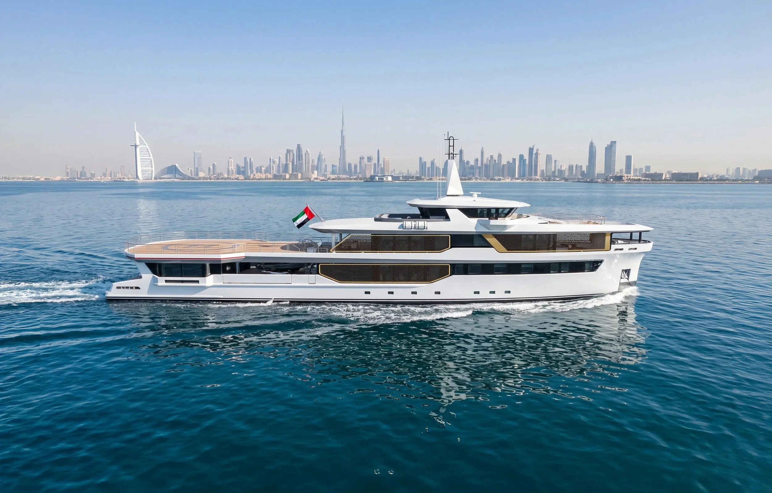 A luxury yacht with a Dubai flag sailing on clear blue water with Dubai skyline, including the Burj Khalifa, in the background.